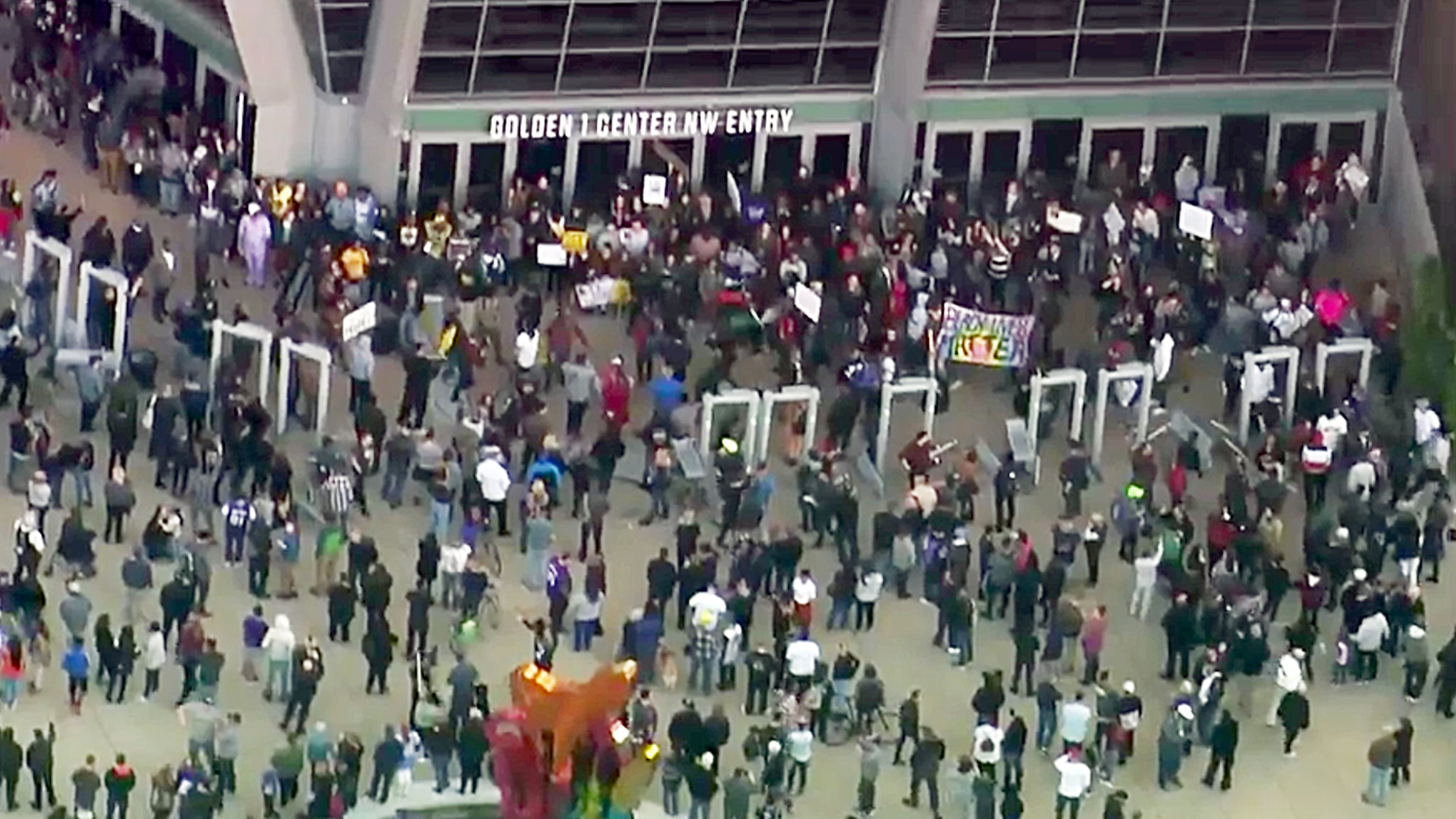 This photo from video provided by KCRA3 shows demonstrators protesting this week's fatal shooting of an unarmed black man and mingling with fans outside Golden Center, just before the tipoff of an NBA basketball game between the Atlanta Hawks and the Sacramento Kings in Sacramento, Calif., Thursday, March 22, 2018. Hundreds of people rallied for Stephon Clark, a 22-year-old who was shot Sunday in his grandparents' backyard. Police say they feared he had a handgun when they confronted him after reports that he had been breaking windows, but he only had a cellphone. (KCRA3 via AP)