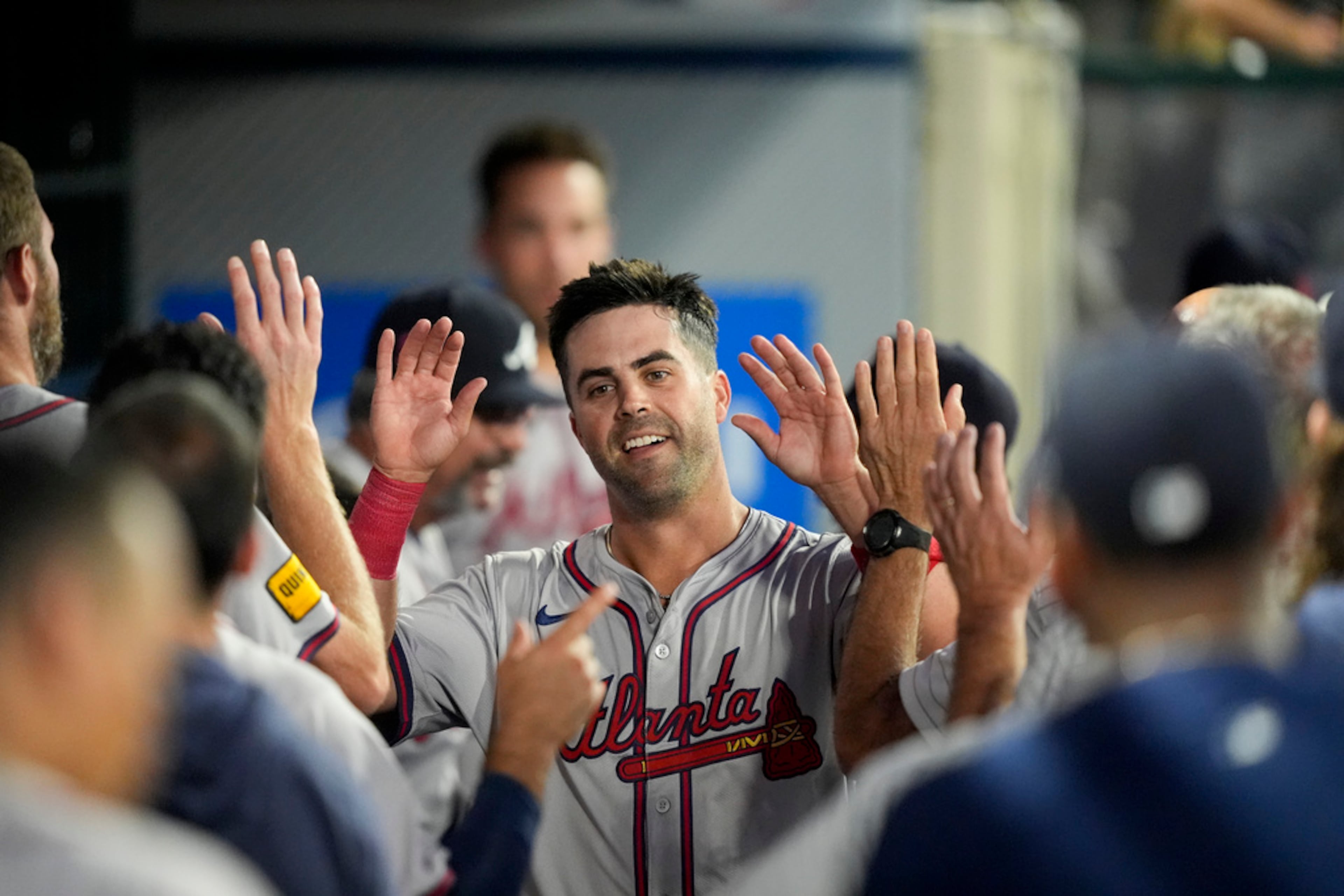 Atlanta Braves' Whit Merrifield celebrates in the dugout after a solo home run during the fifth inning of a baseball game against the Los Angeles Angels, Saturday, Aug. 17, 2024, in Anaheim, Calif. (AP Photo/Ryan Sun)