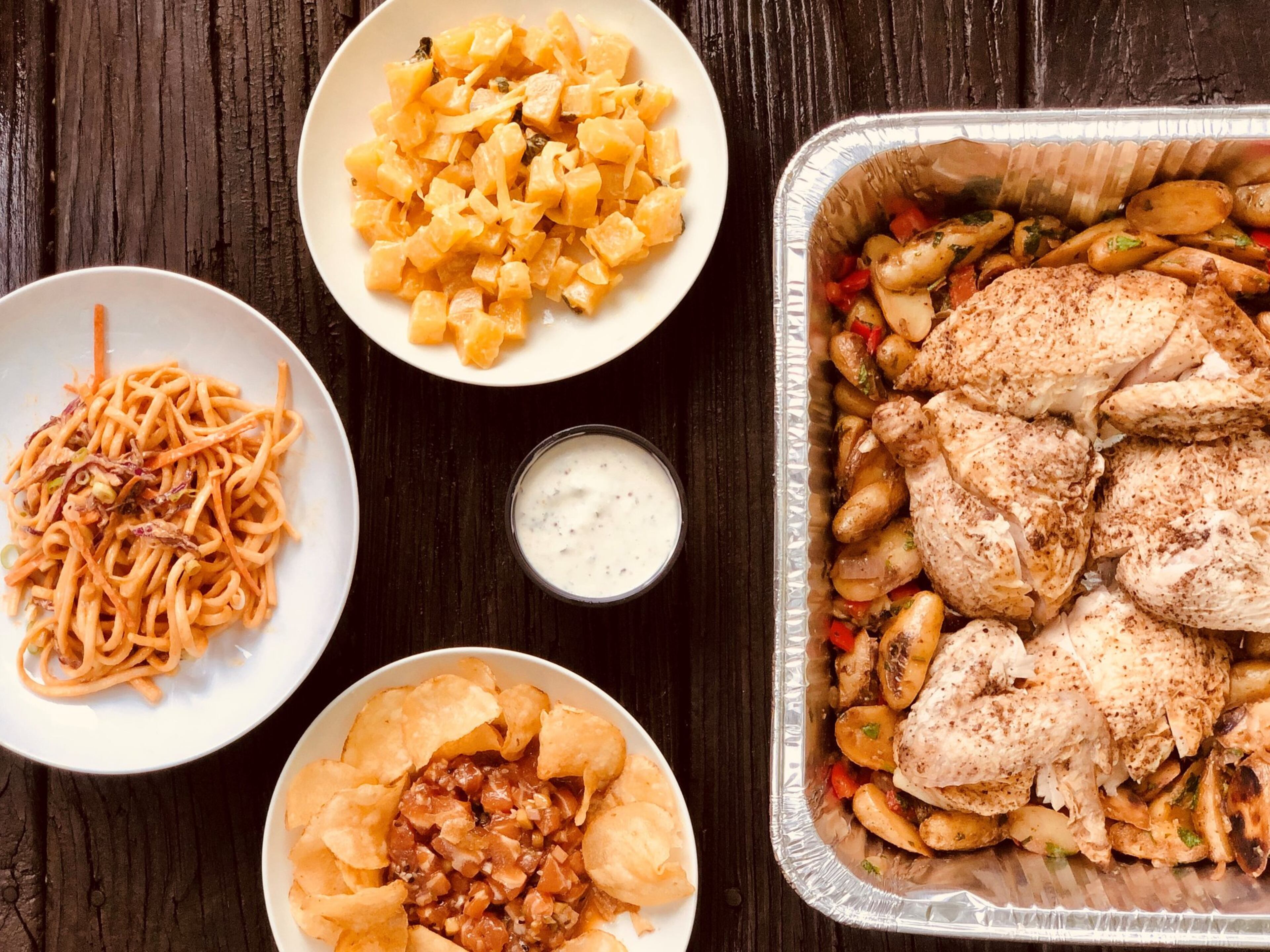 Takeout from Poor Hendrix: clockwise from left; spicy cold sesame noodles; golden beet salad; roast chicken with fingerling potatoes and garlic lemon aioli (center); salmon tartare with chips. Contributed by Wendell Brock