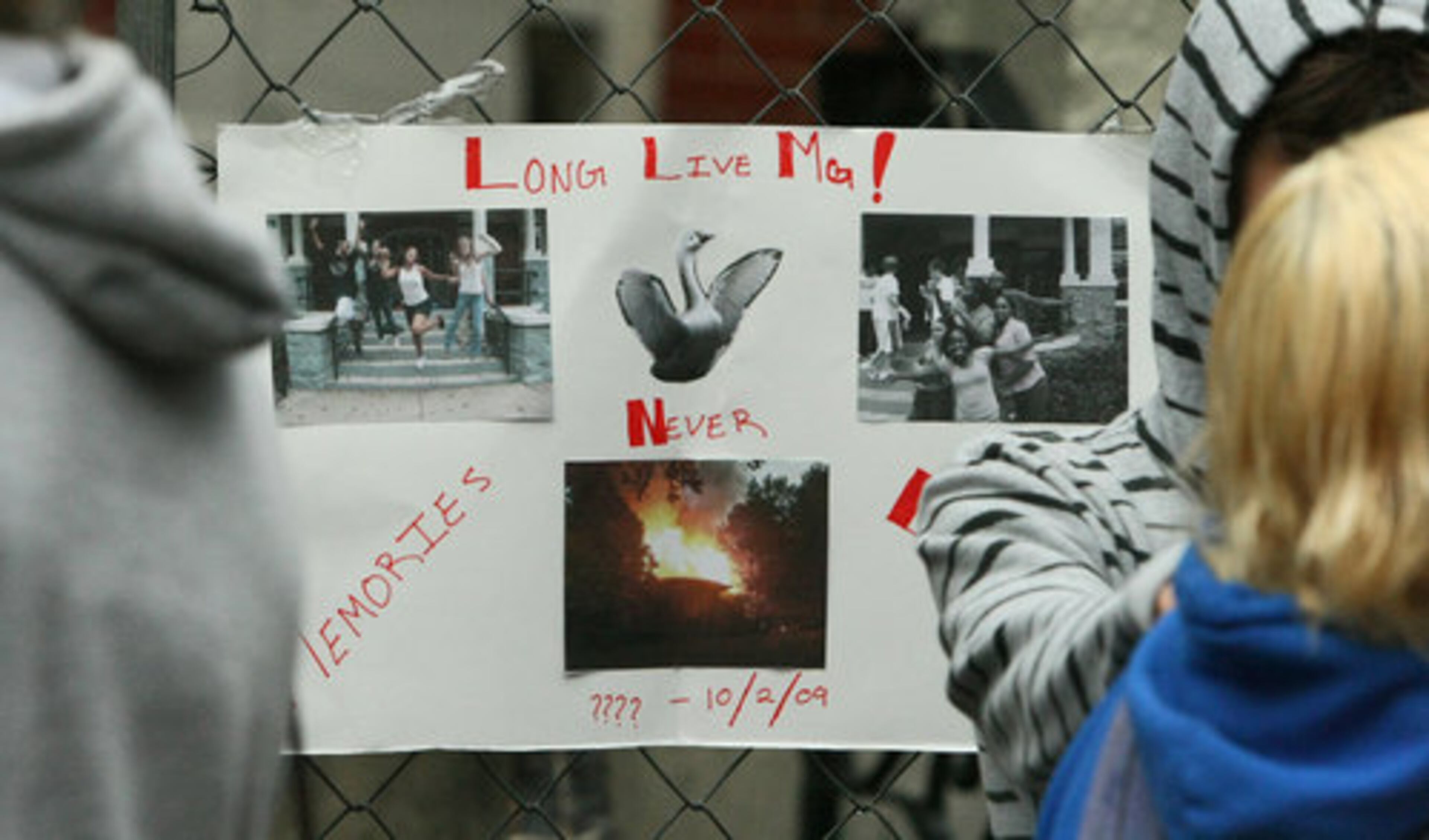 A poster detailing memories of the burned building hangs at the school on Monday.