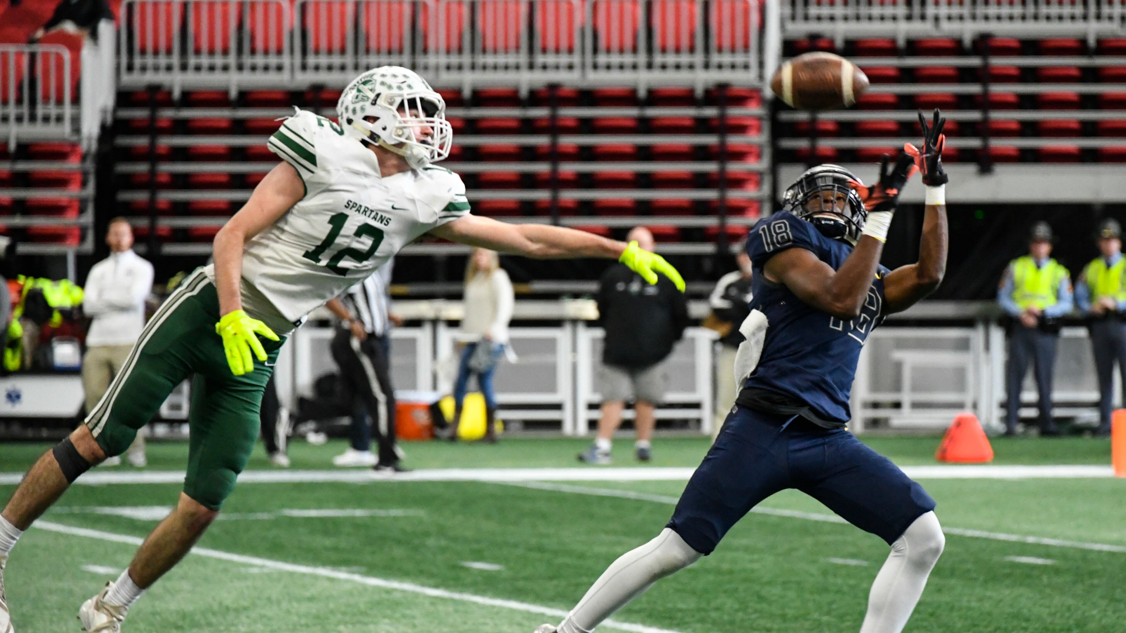 Eagle's Landing Christian Academy's Justin Menard makes a catch as Athens Academy LB Barrett McLanahan defends during the third quarter of Wednesday's Class A private state title game at Mercedes-Benz Stadium. (John Amis/Special)