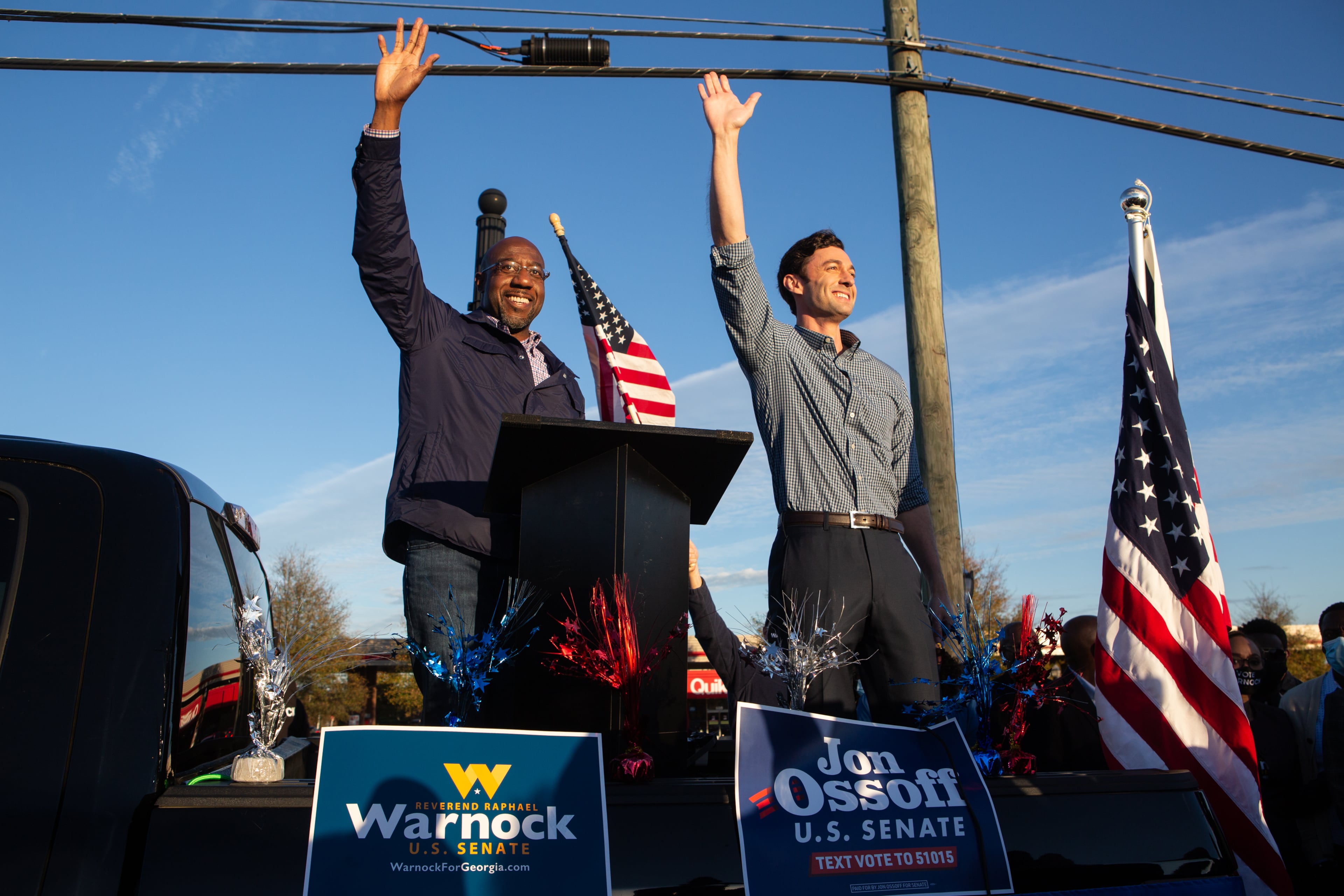 Democratic U.S. Senate candidates Jon Ossoff (R) and Raphael Warnock (L) of Georgia wave to supporters during a rally on November 15, 2020 in Marietta, Georgia. Ossoff and Warnock face incumbent U.S. Sens. David Purdue (R-GA) and Kelly Loeffler (R-GA) respectively in a runoff election January 5, 2021. (Jessica McGowan/Getty Images/TNS)