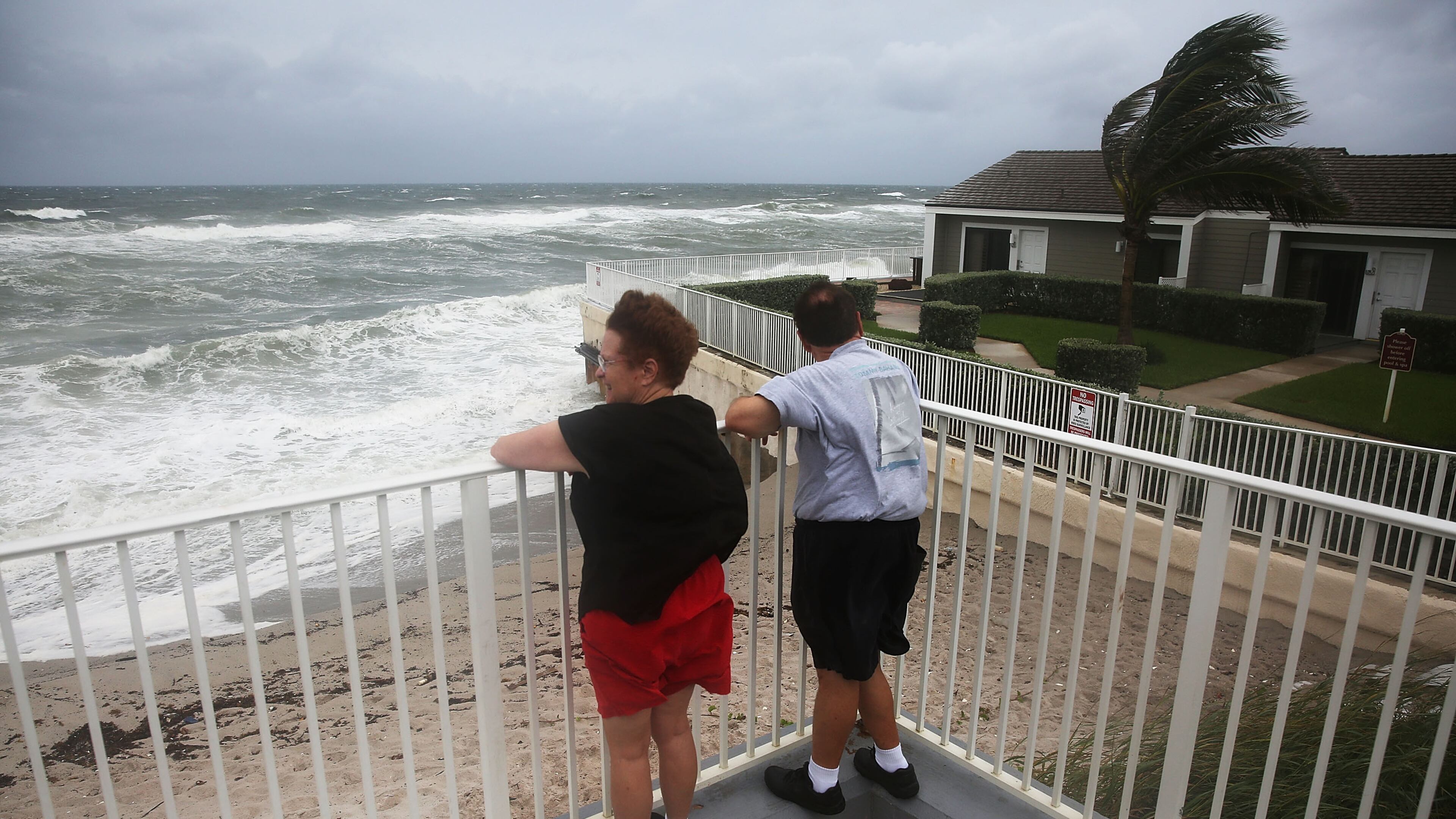 JUPITER, FL - OCTOBER 06: Karen Lanman and Don Lanman look out at the churning ocean as Hurricane Matthew approaches the area on October 6, 2016 in Jupiter, Florida. The hurricane is expected to make landfall sometime this evening or early in the morning as a possible category 4 storm. (Photo by Joe Raedle/Getty Images)