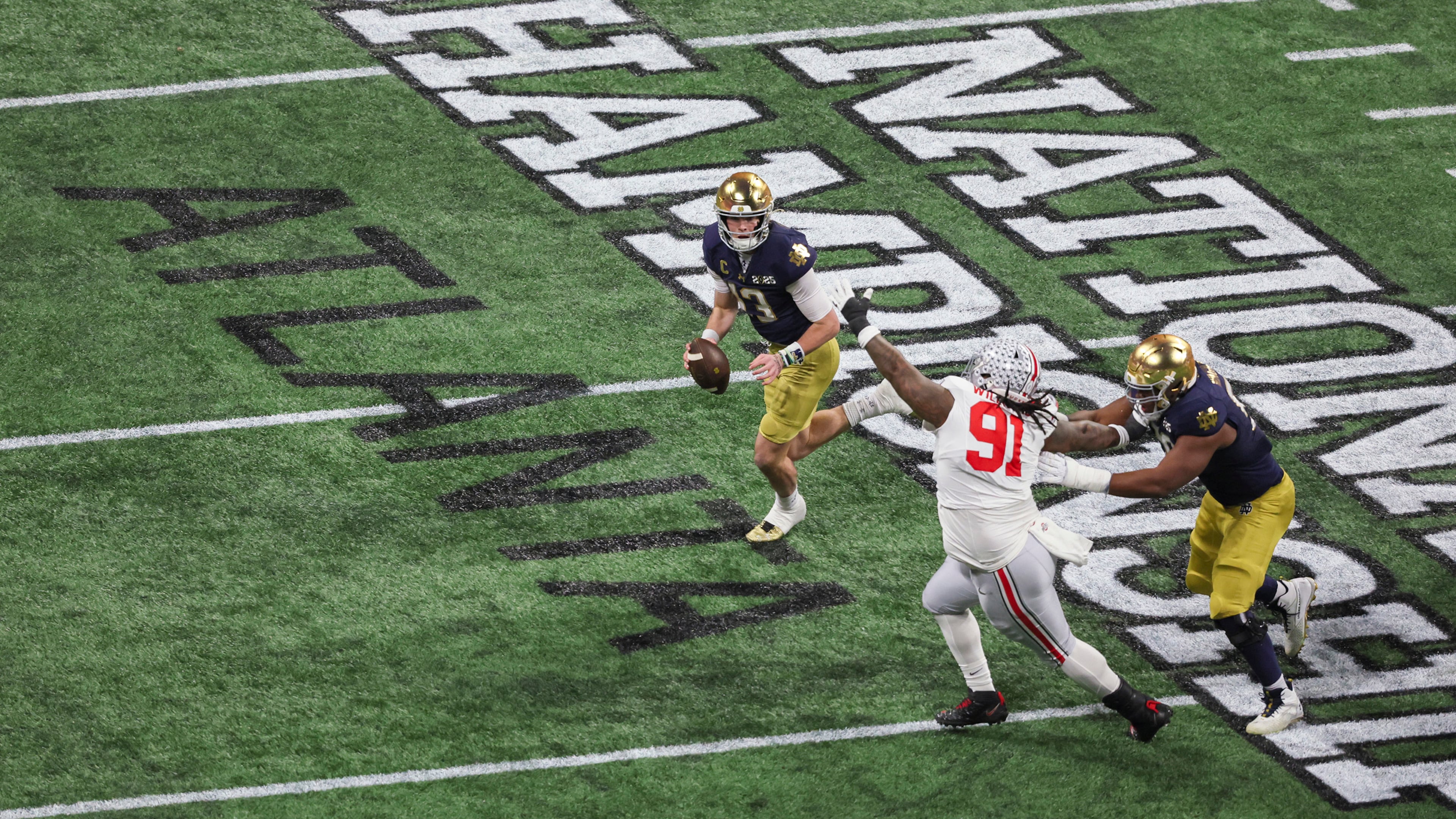Notre Dame quarterback Riley Leonard (13) runs against Ohio State defensive tackle Tyleik Williams (91) during the first half of the 2025 National Championship at Mercedes-Benz Stadium, Monday, Jan. 20, 2025, in Atlanta. (Jason Getz/AJC)