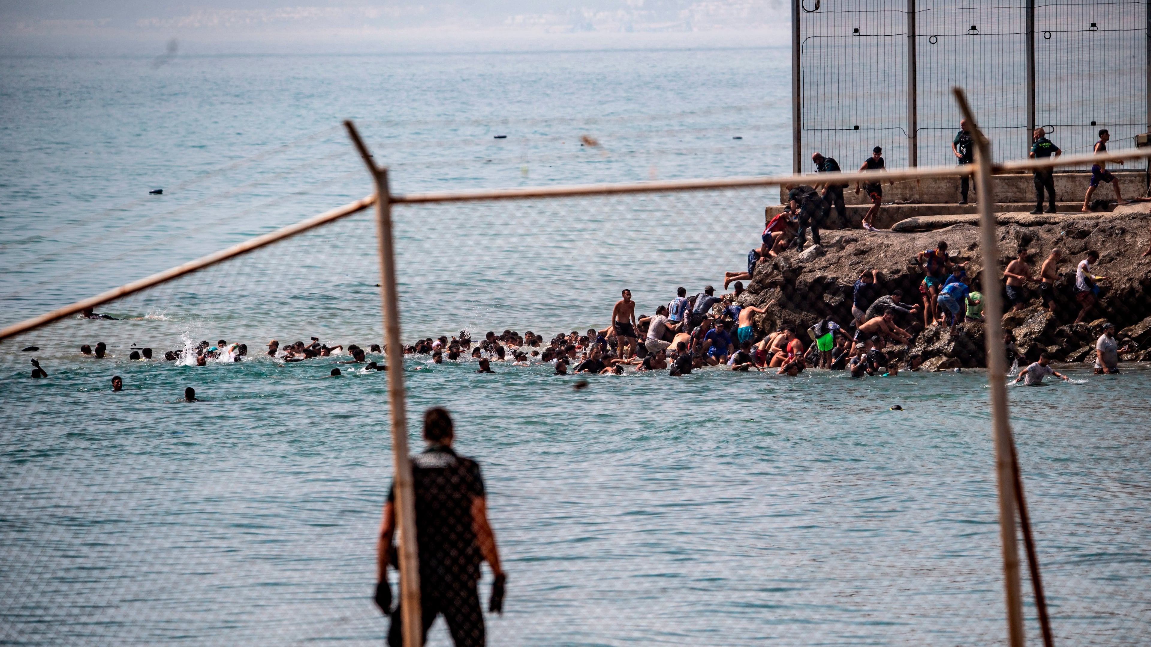 Migrants cross from Morocco into the Spanish enclave of Ceuta, Thursday, July 30, 2026. (AP Photo/Antonio Sempere)