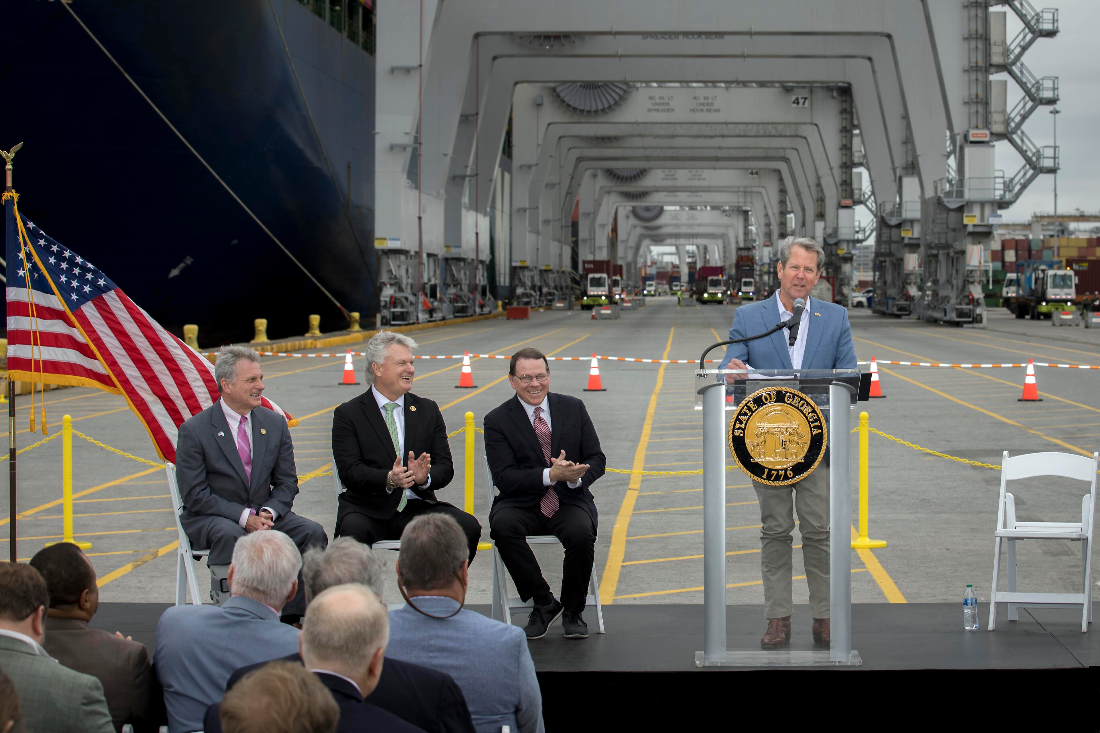 Gov. Brian Kemp (right) speaks during a visit to the Port of Savannah with (left to right) U.S. Reps. Buddy Carter and Mike Collins of Georgia and Sam Graves of Missouri.