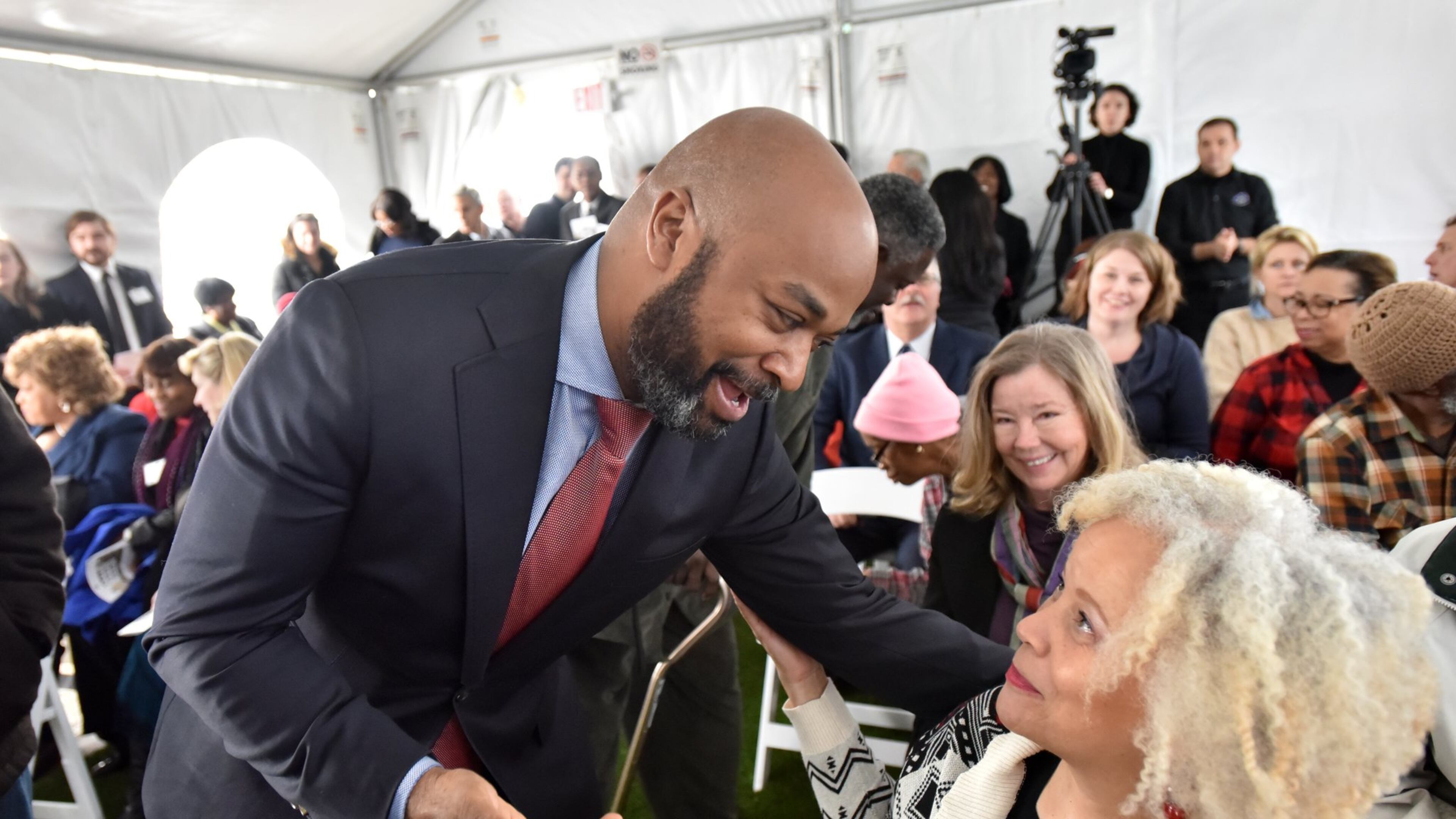December 15, 2016 Atlanta - Atlanta City Councilman Kwanza Hall (left) greets Lynne Alston-Leonard (right) before the grand opening of the City of Lights, a new affordable senior housing facility in Old Fourth Ward on Thursday. HYOSUB SHIN / HSHIN@AJC.COM