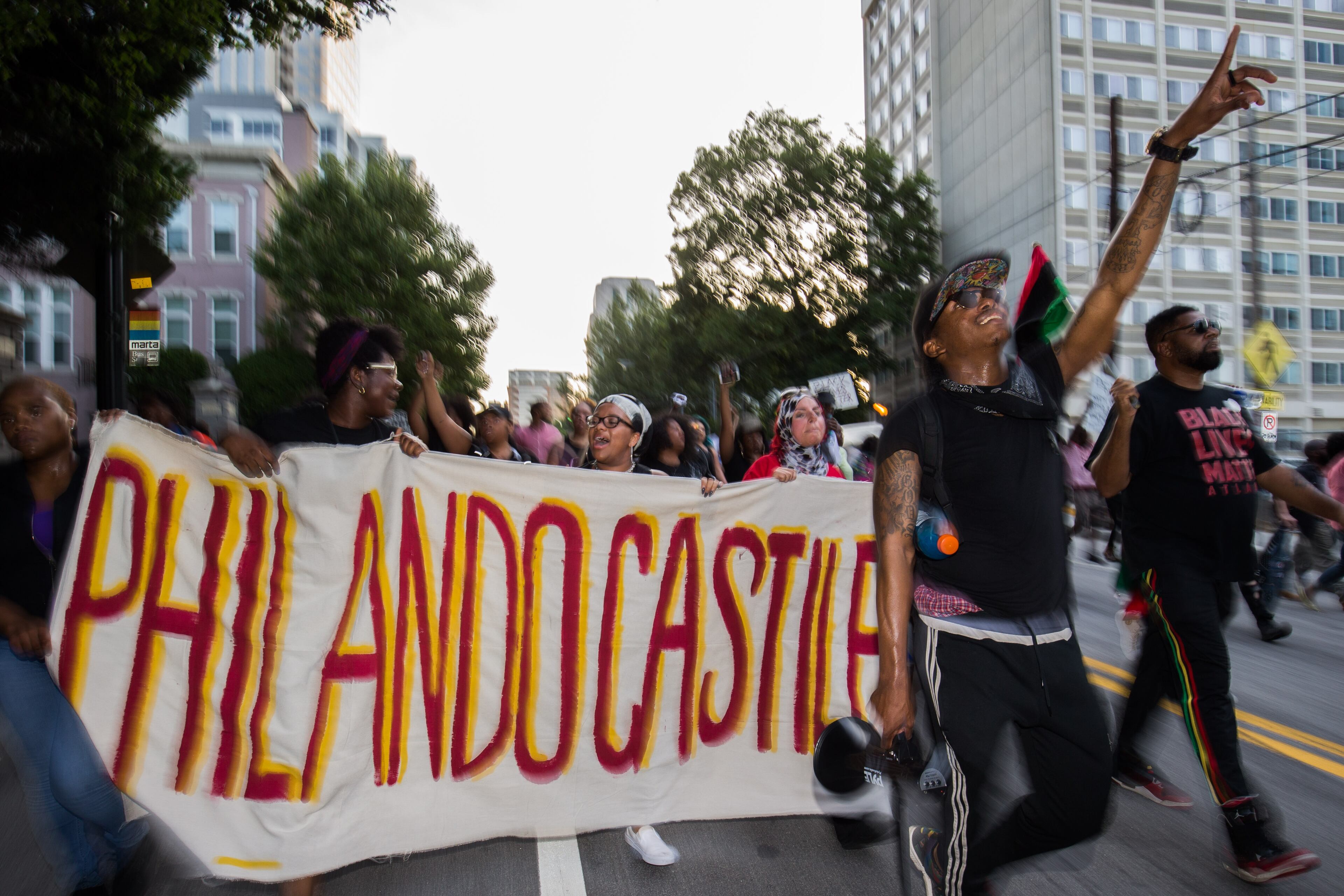Demonstrators with signs march down Peachtree Street to Piedmont Park, Thursday, July 7, 2016, in Atlanta, in response to the death ofAlton Sterling, 37, who was killed by Baton Rouge police outside of a convenience store where he was selling CDs, and Philando Castile, who was shot and killed when Minnesota police stopped him for a traffic violation on Wednesday evening. BRANDEN CAMP/SPECIAL