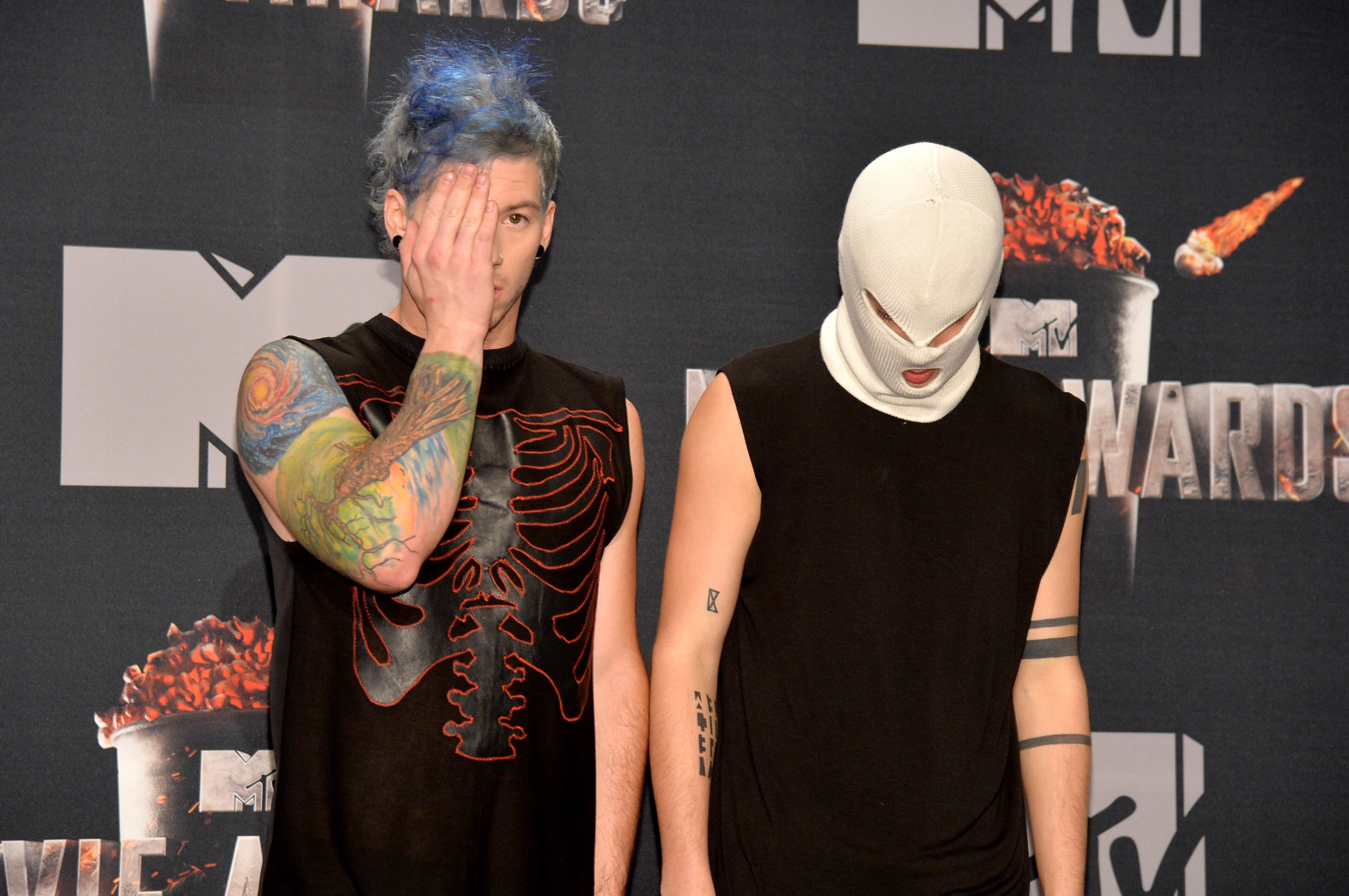 LOS ANGELES, CA - APRIL 13: (L-R) Josh Dun and Tyler Joseph of Twenty One Pilots pose in the press room during the 2014 MTV Movie Awards at Nokia Theatre L.A. Live on April 13, 2014 in Los Angeles, California. (Photo by Michael Buckner/Getty Images)