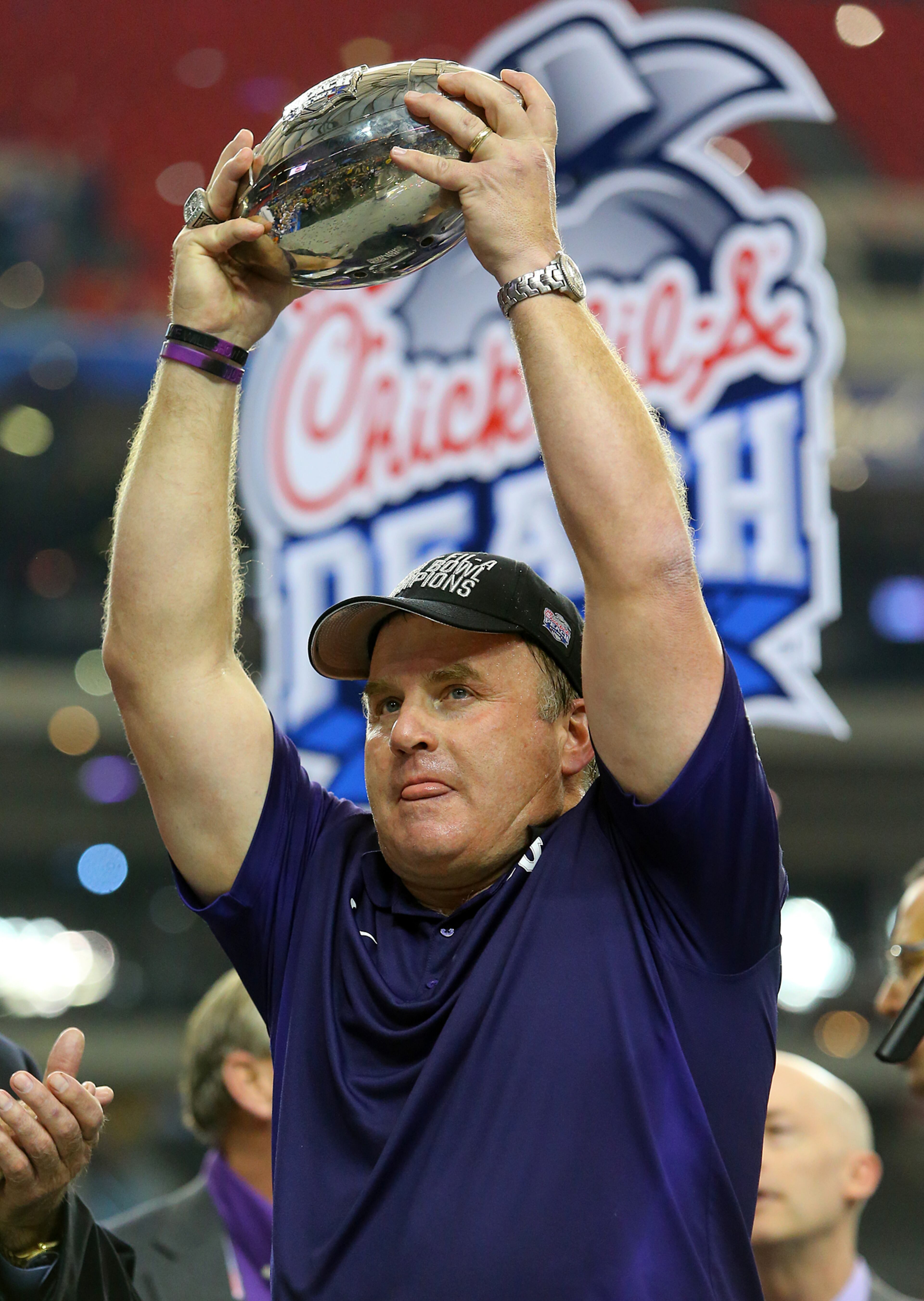 TCU head coach Gary Patterson hoists the Chick-fil-A Peach Bowl trophy on Wednesday, Dec. 31, 2014, in Atlanta. TCU beat Ole Miss 42-3. Curtis Compton / ccompton@ajc.com