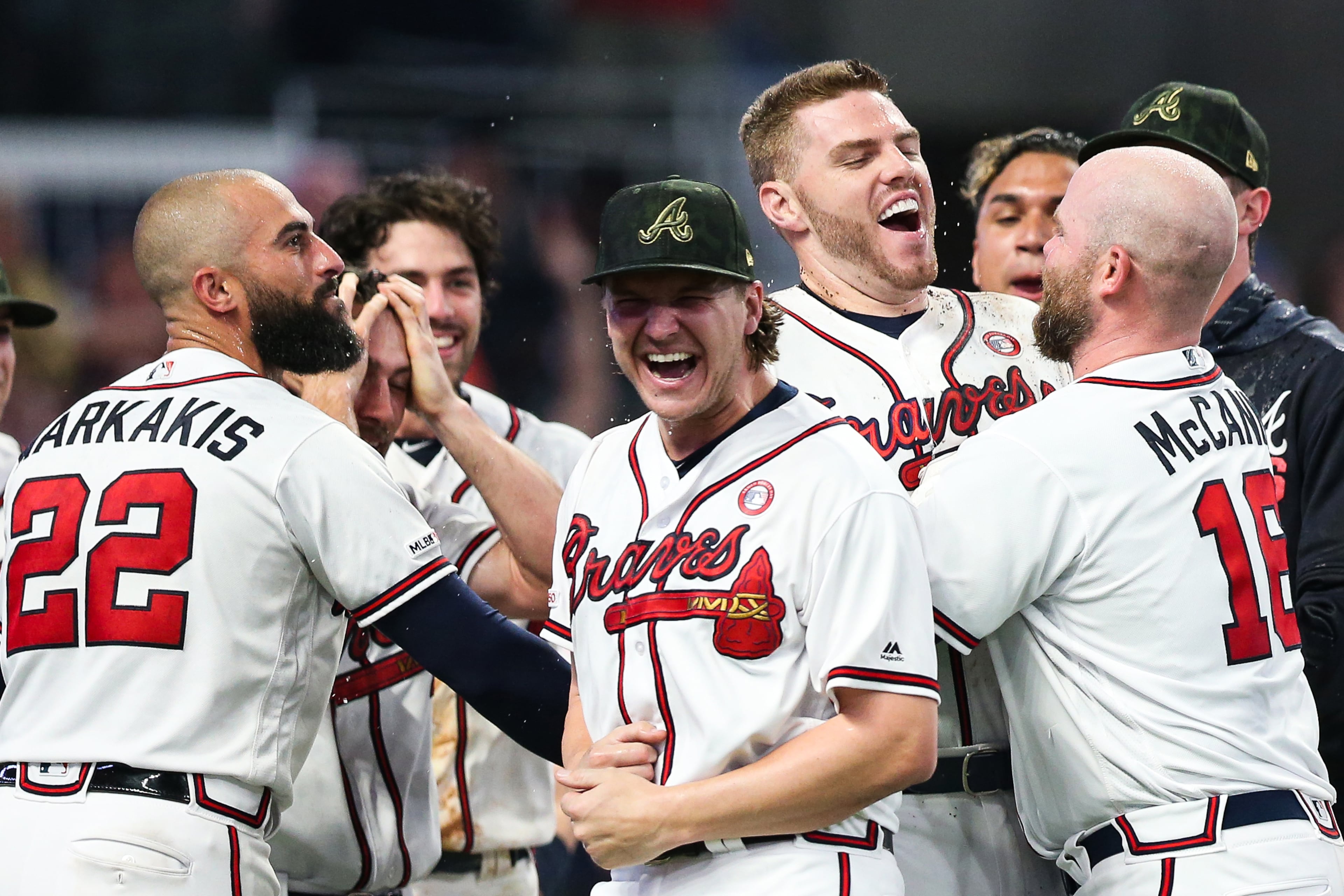 Nick Markakis (22) Brian McCann (16) and other Braves
celebrate a walk off home run hit by Freddie Freeman. (Photo by Carmen Mandato/Getty Images)