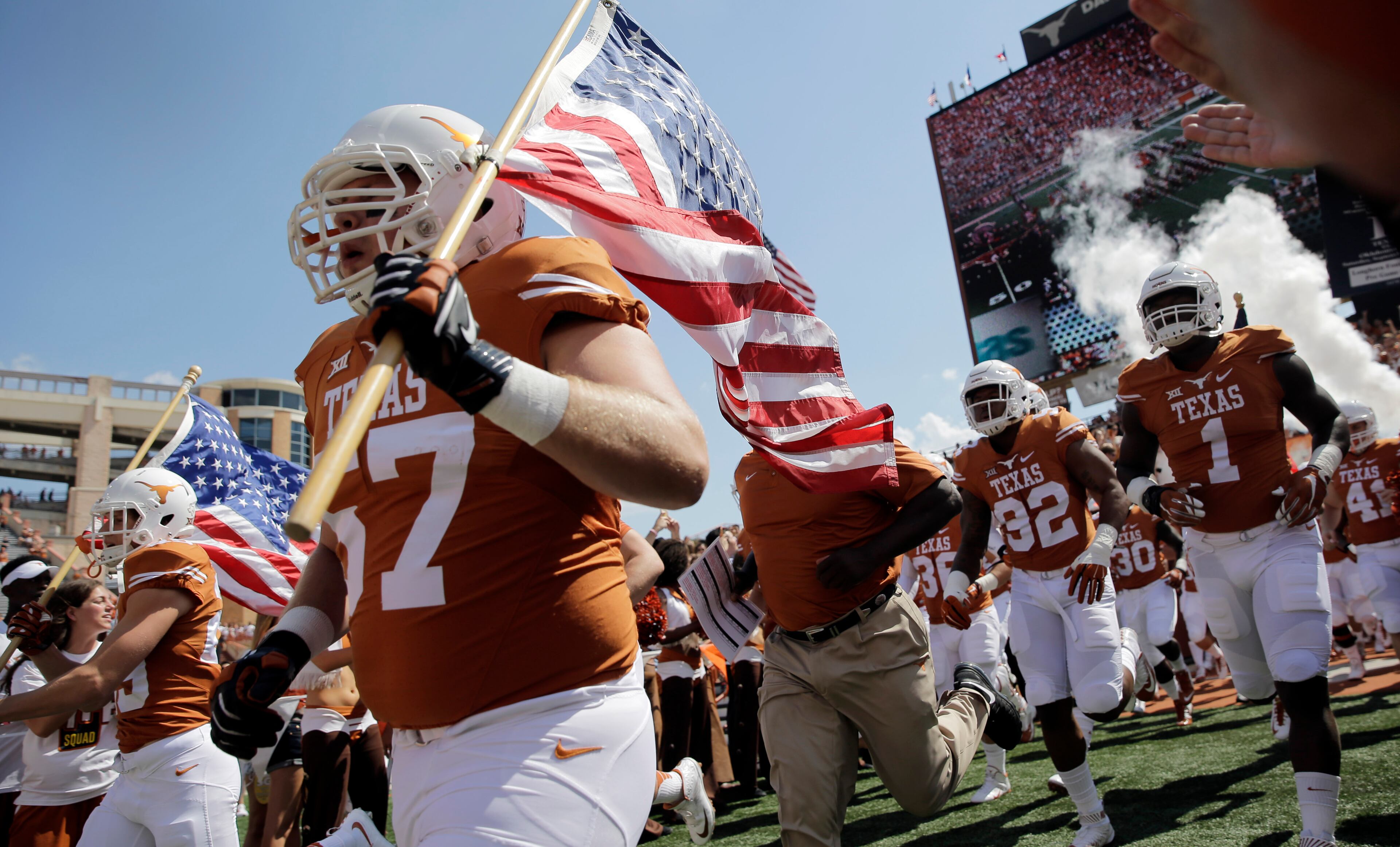 Texas players enter the stadium before an NCAA college football game against Oklahoma State, Saturday, Sept. 26, 2015, in Austin, Texas. (AP Photo/Eric Gay)