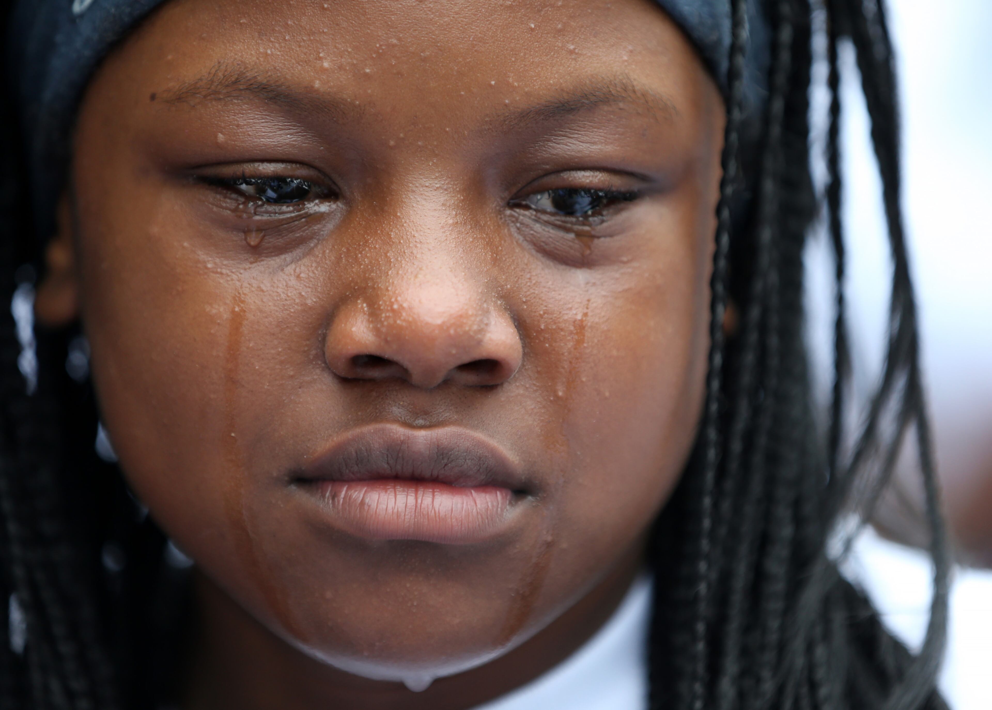 October 1, 2015 Atlanta: Tears stream down 11-year-old Janiyah Humphrey's face during a vigil for her cousin Tiara Bogan Jones on Thursday evening October 1, 2015 near where the 25-year-old mother of two was shot and killed early Saturday morning in Southeast Atlanta. Ben Gray / bgray@ajc.com