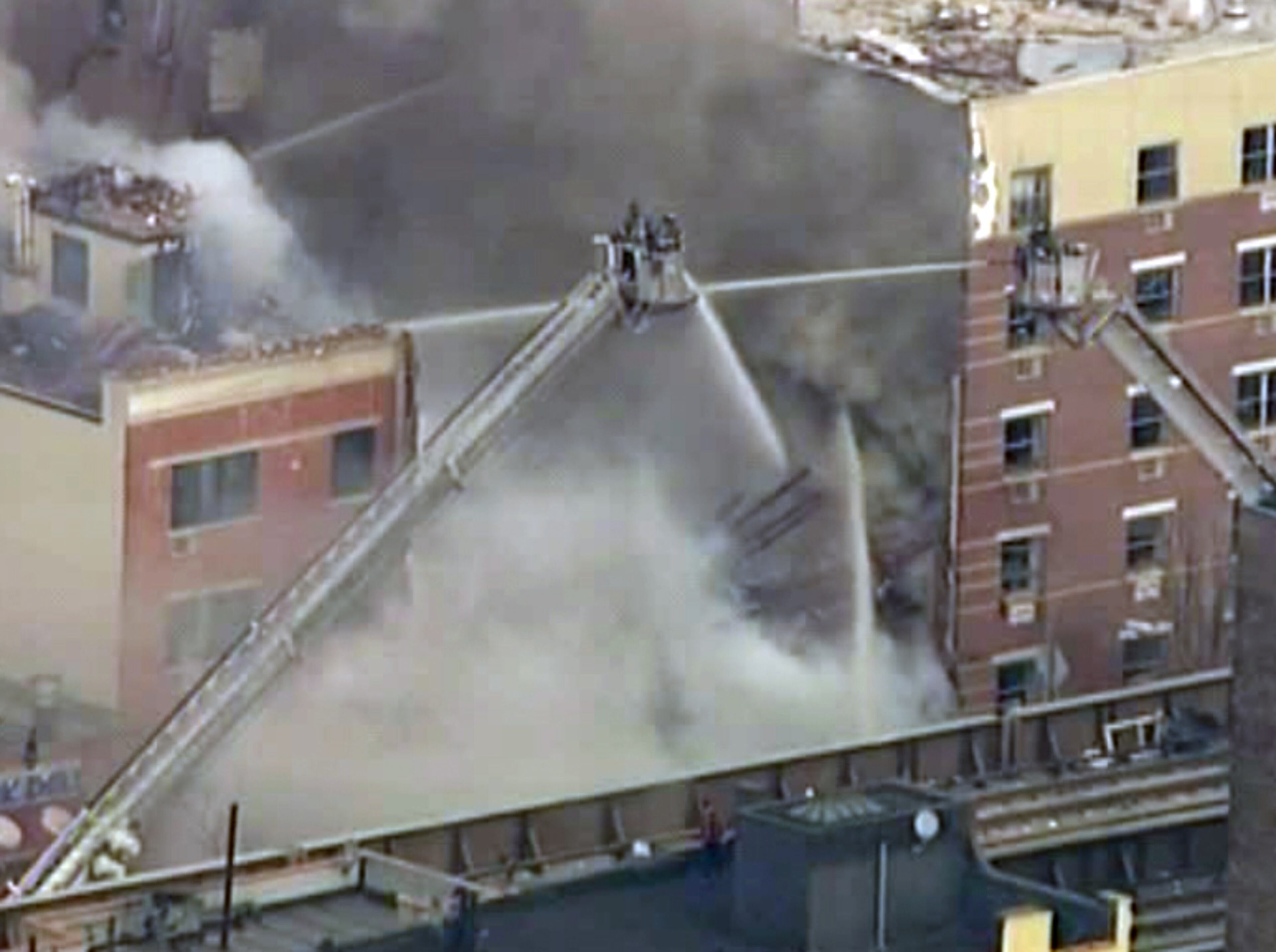 In this image taken from video from WABC, firefighters battle a blaze at the site of a possible explosion and building collapse in the East Harlem neighborhood of New York, Wednesday, March 12, 2014. (AP Photo/WABC-TV)
