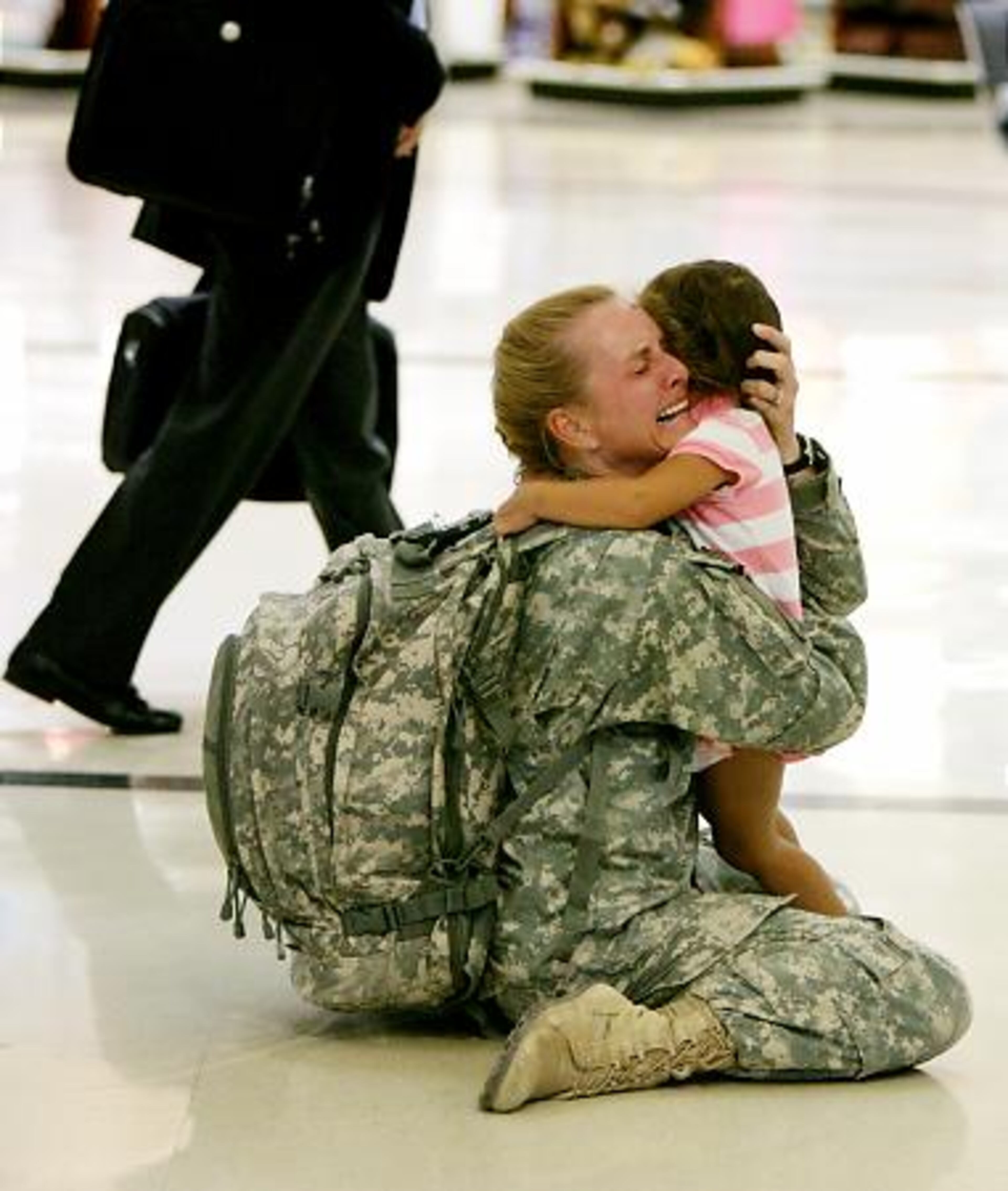 Terri Gurrola greets her 3-year-old daughter, Gabrielle Gurrola, at Hartsfield-Jackson International Airport. Gurrola, who served seven months in Iraq, was one of many soldiers walking through the airport on Sept. 11 -some departing for Iraq and others returning.