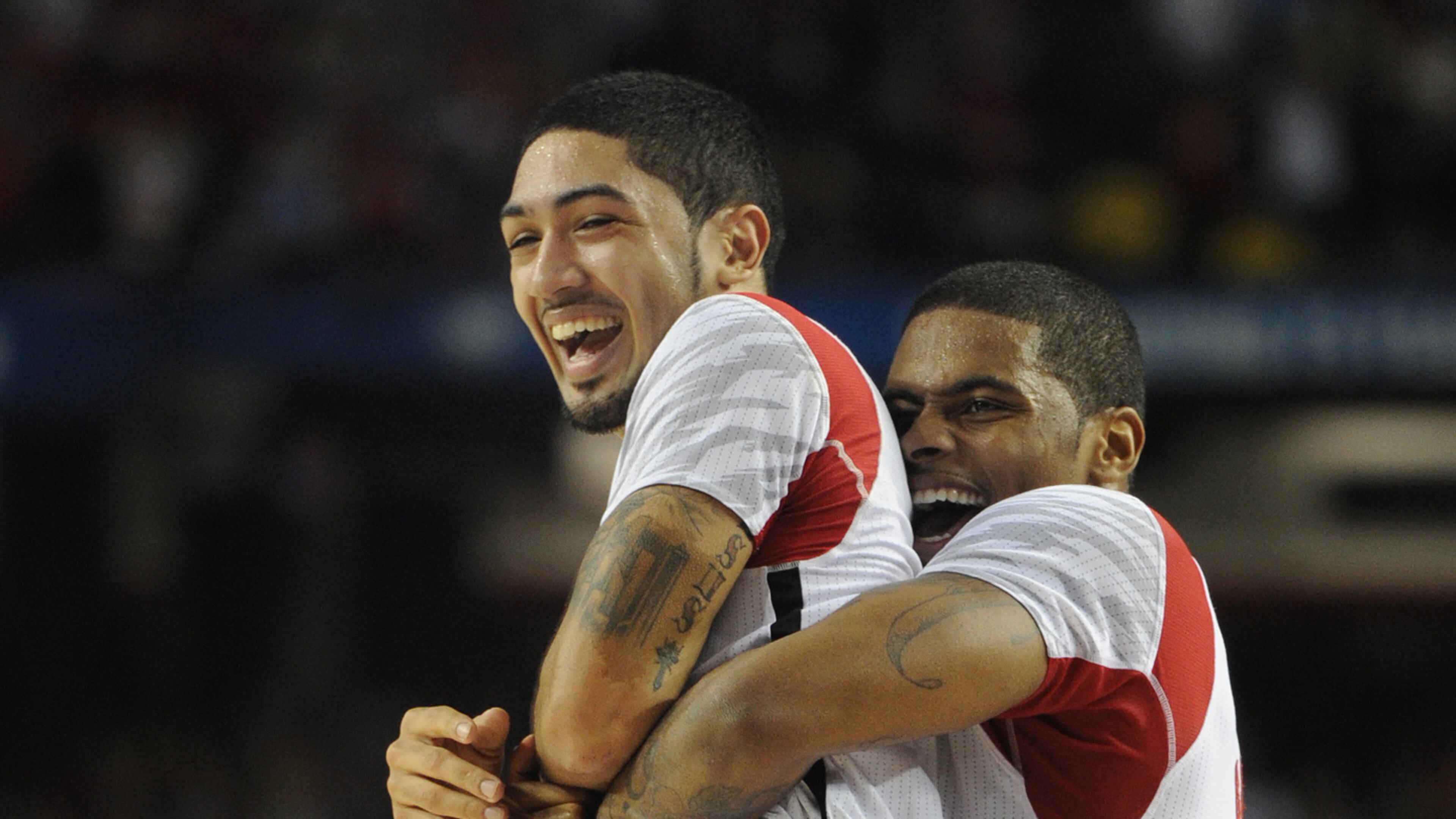 Louisville's Peyton Siva is picked up by Chane Behanan after they won.