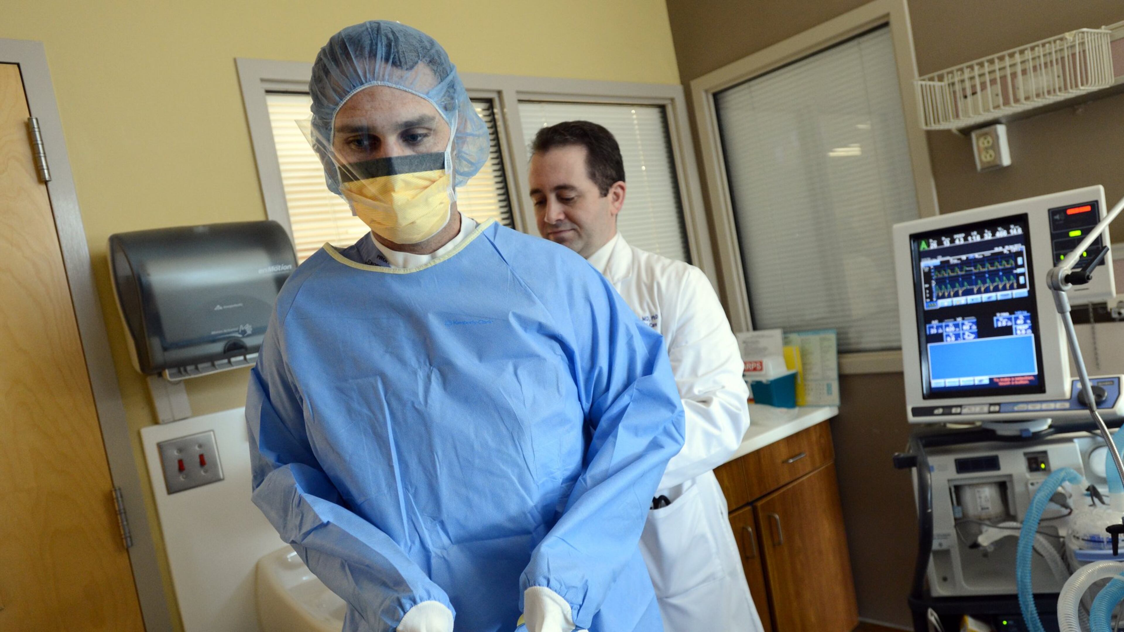 Dr. David Murphy (right) helps Dr. Justin Schrager as they prepare placing central line in a patient’s room at Medical ICU of Grady Memorial Hospital on Friday, April 5, 2013. Dr. David Murphy, leader of a successful effort at Grady to reduce hospital infections.