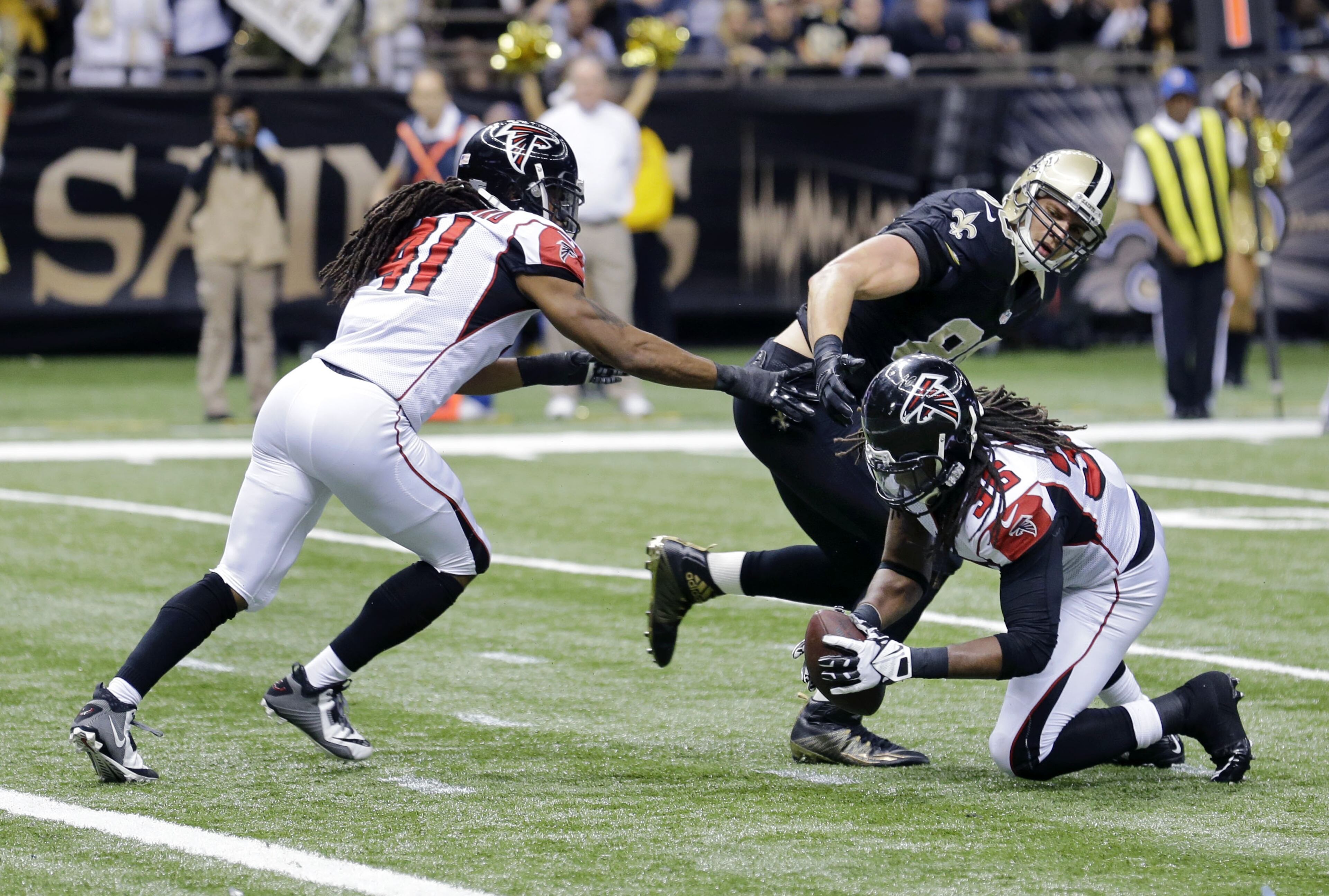 Atlanta Falcons strong safety Kemal Ishmael (36) scoops up a fumble after a reception by New Orleans Saints tight end Jimmy Graham (80) at the goal line in the second half of an NFL football game in New Orleans, Sunday, Dec. 21, 2014. (AP Photo/Bill Haber)