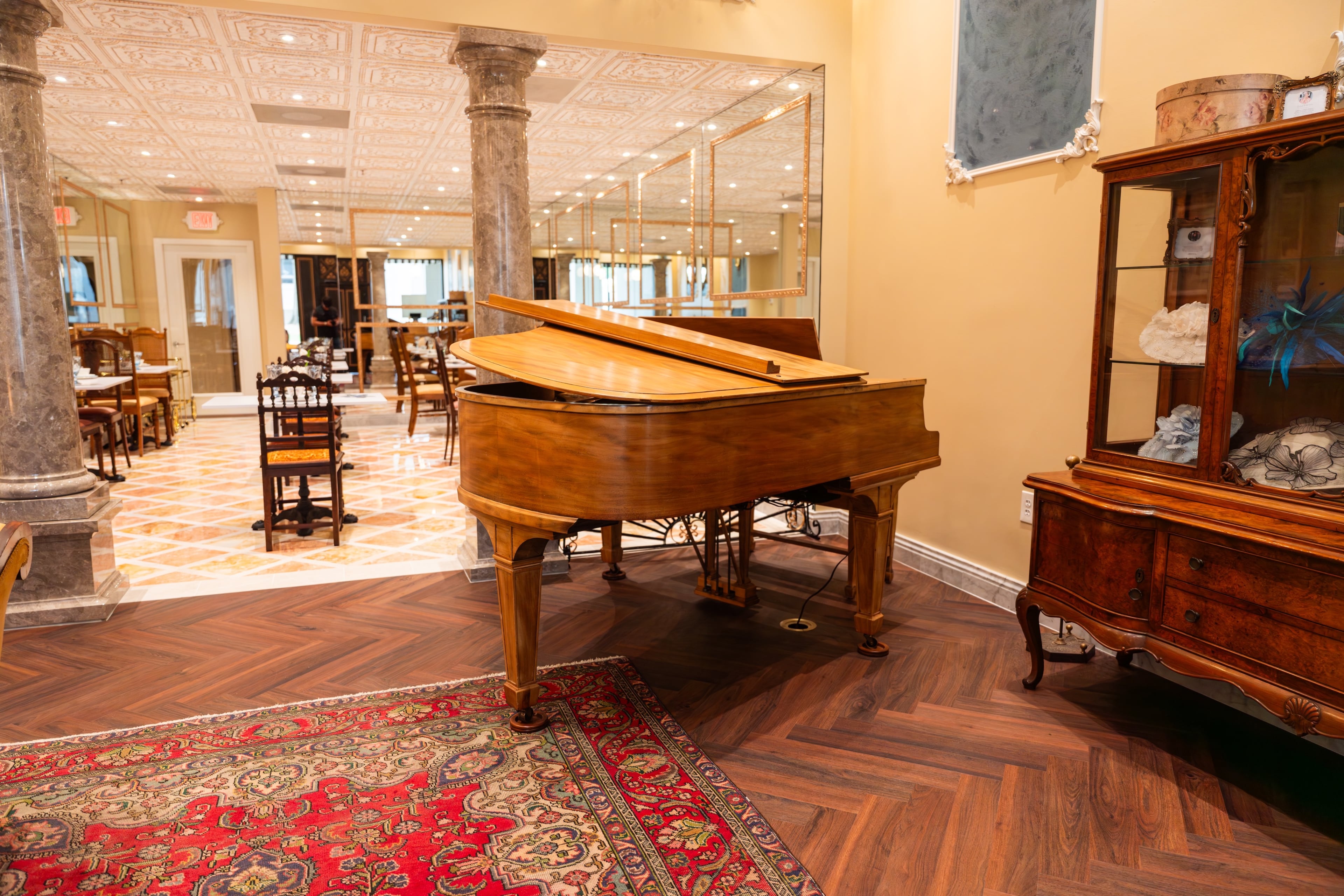 A baby grand piano greets customers as they enter Le Faucheur’s main tea room. (Courtesy of Daniel Fatemi/Le Faucheur)