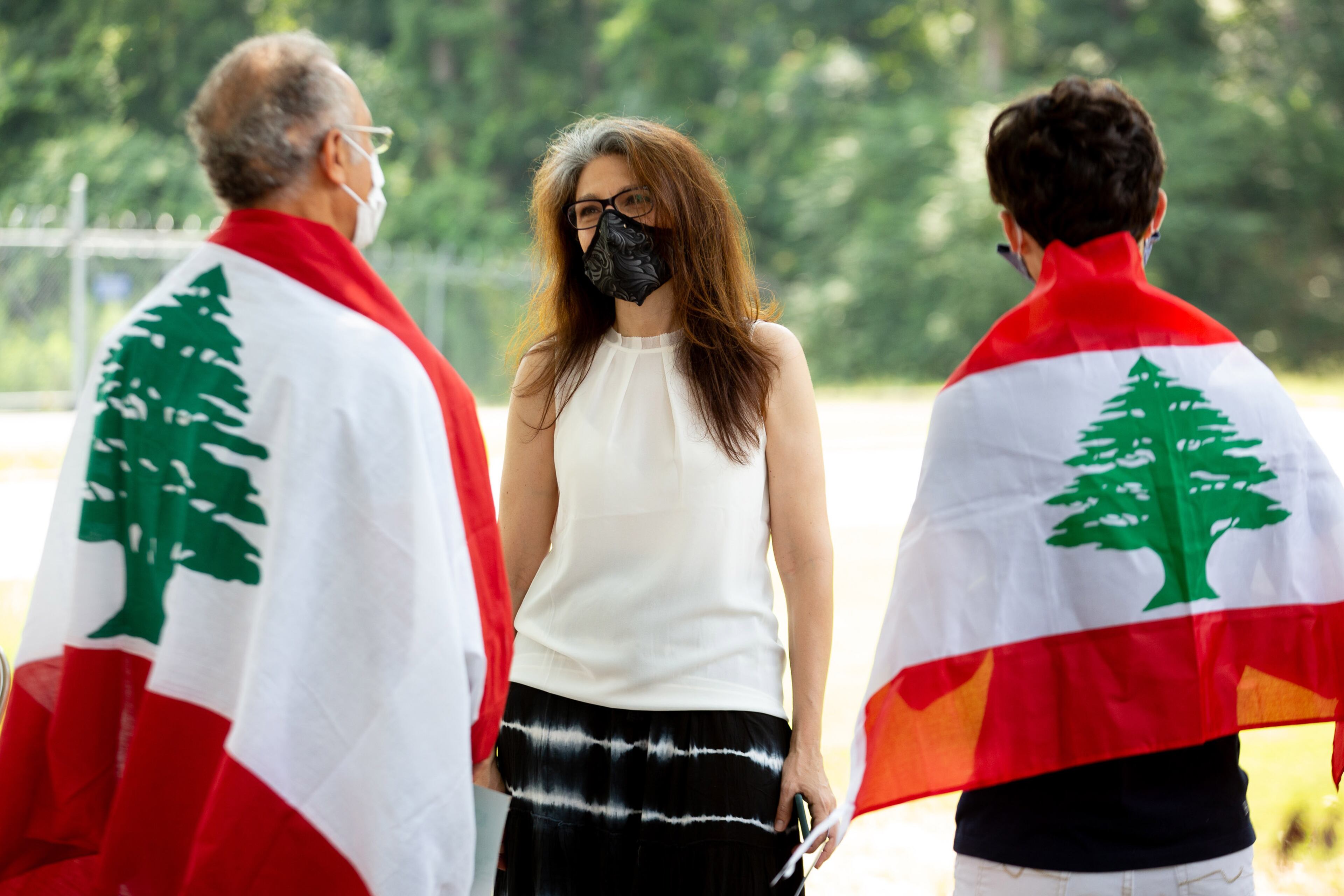 Alec Elchahal (L) and his son Ryal (R) talk with the Alif Institute interim director Alta Schwartz during a vigil for the Lebanese people at the Alif Institute in Atlanta on Sunday, August 9, 2020. The event was to honor the victims of a deadly blast in Beirut, Lebanon, last week. STEVE SCHAEFER FOR THE ATLANTA JOURNAL-CONSTITUTION