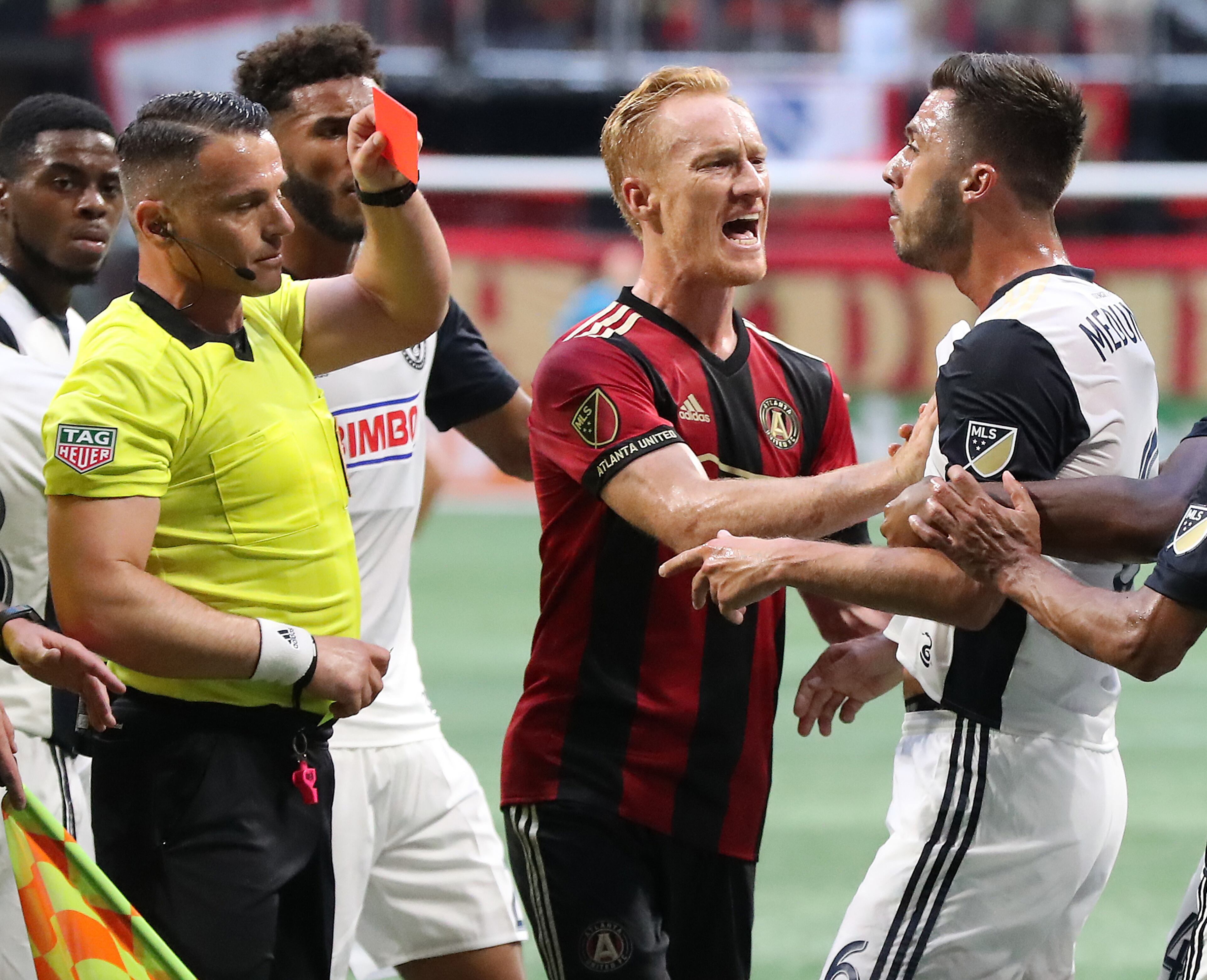 June 2, 2018 Atlanta: An official pulls a red card on Philadelphia Union midfielder Haris Medunjanin as Atlanta United midfielder Jeff Larentowicz holds him back while he argues a call during the first half in a MLS soccer match on Saturday, June 2, 2018, in Atlanta. Two Philadelphia Union players drew red cards on the play and were ejected from the game. Curtis Compton/ccompton@ajc.com