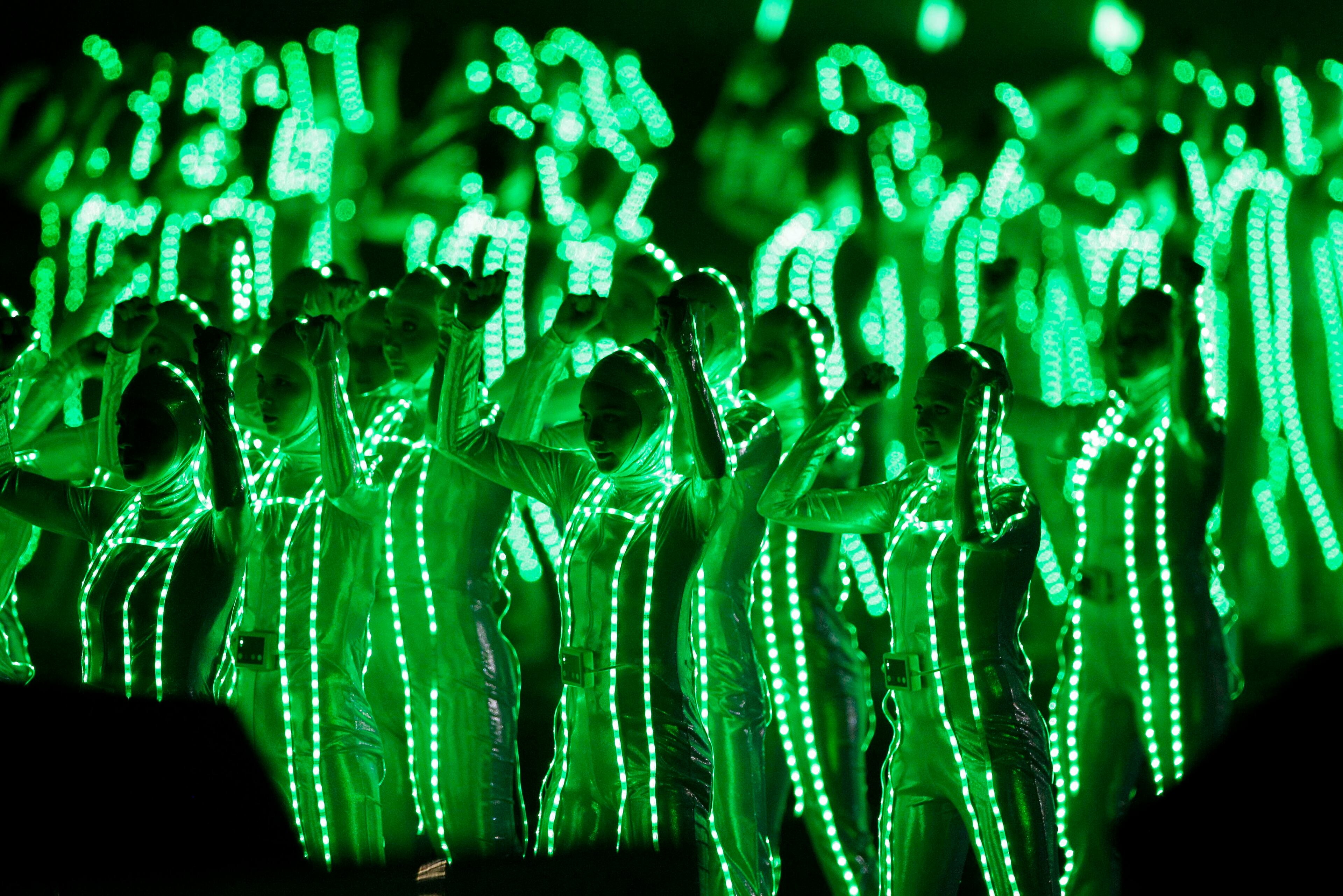 Dancers perform in lighted suits as The Black Eyed Peas perform at halftime.
