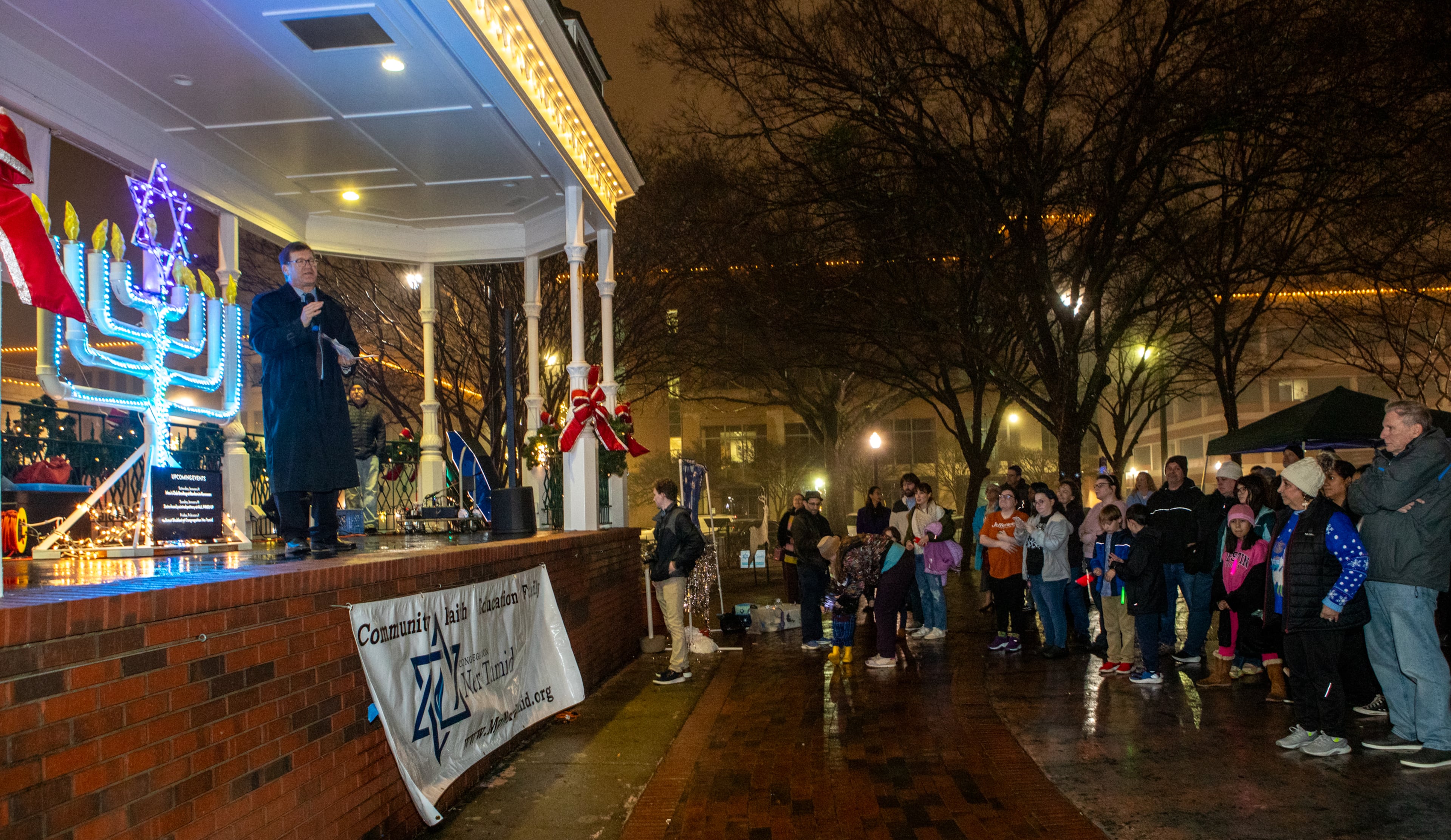 Congregation Ner Tamid’s Rabbi Joseph Prass leads a menorah lighting on the fifth night of Hanukkah on Saturday, Dec 28, 2024. The temple provided arts and crafts, food, music, dreidels, gifts and community at the Glover Park Stage in Marietta Square. This year's menorah lighting in Marietta Square will be Dec. 20, 2025. (Jenni Girtman for The Atlanta Journal-Constitution)