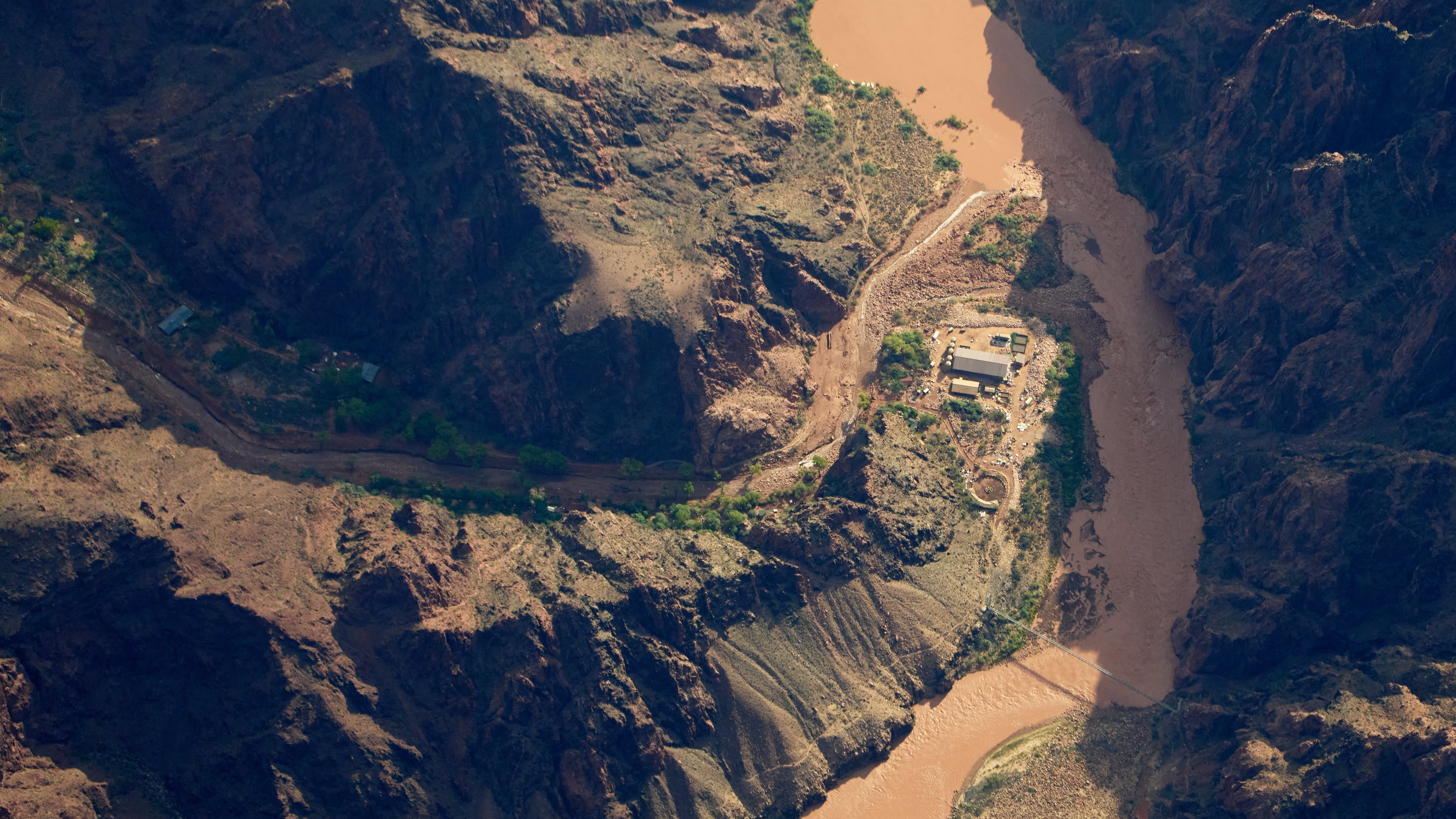 Bright Angel Canyon, damaged by flash floods, runs into the Colorado River in the Grand Canyon, Monday, Aug. 31, 2026, at Grand Canyon National Park, Ariz. (AP Photo/John Locher)