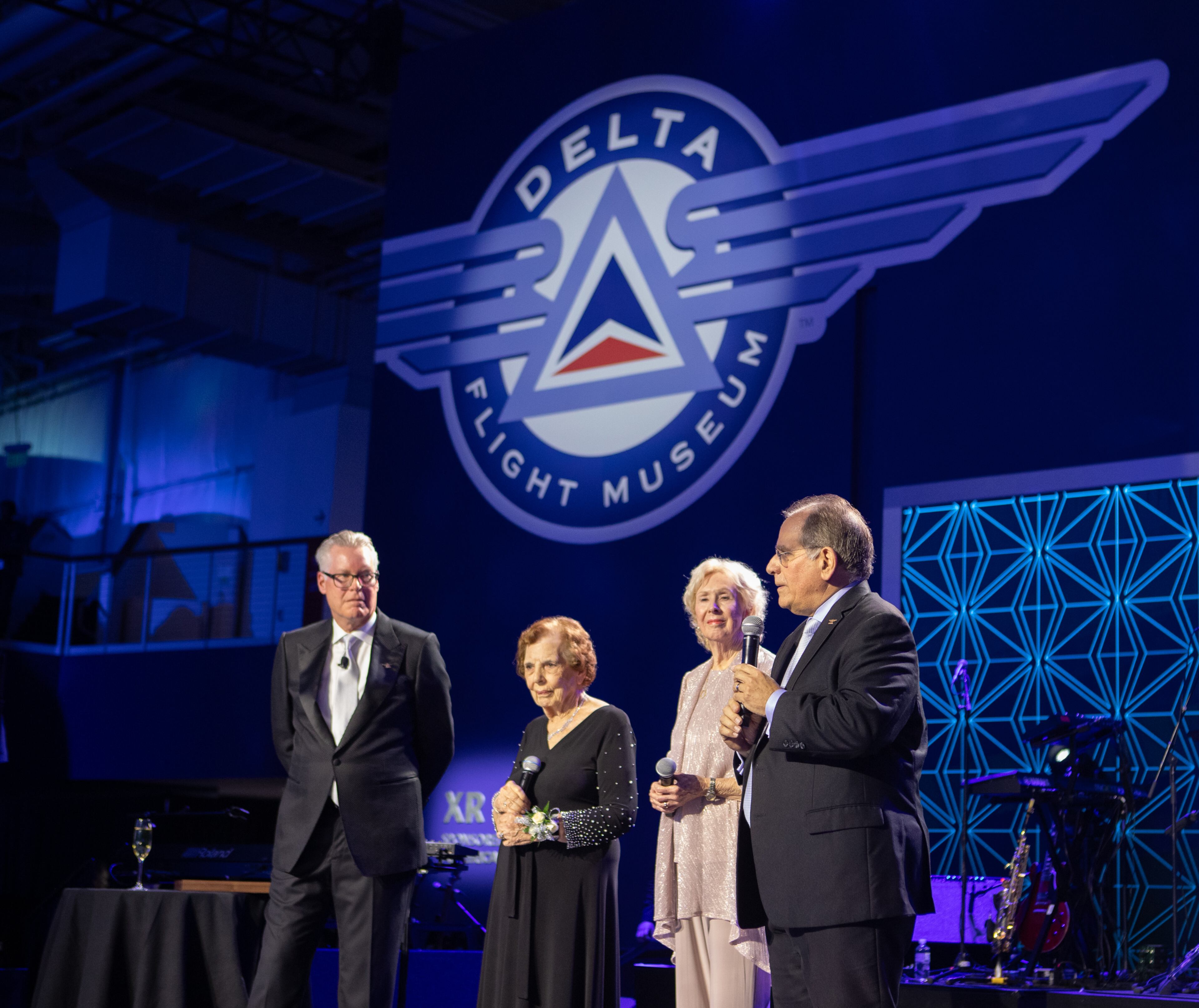 Delta Air Lines celebrations its 100-year anniversary on Saturday, March 15, 2025, at the Delta Flight Museum. James Sarvis, far right, is the vice president of global clean and field stations for Delta, and he addressed the crowd at the gala. (Jenni Girtman for The Atlanta Journal-Constitution)