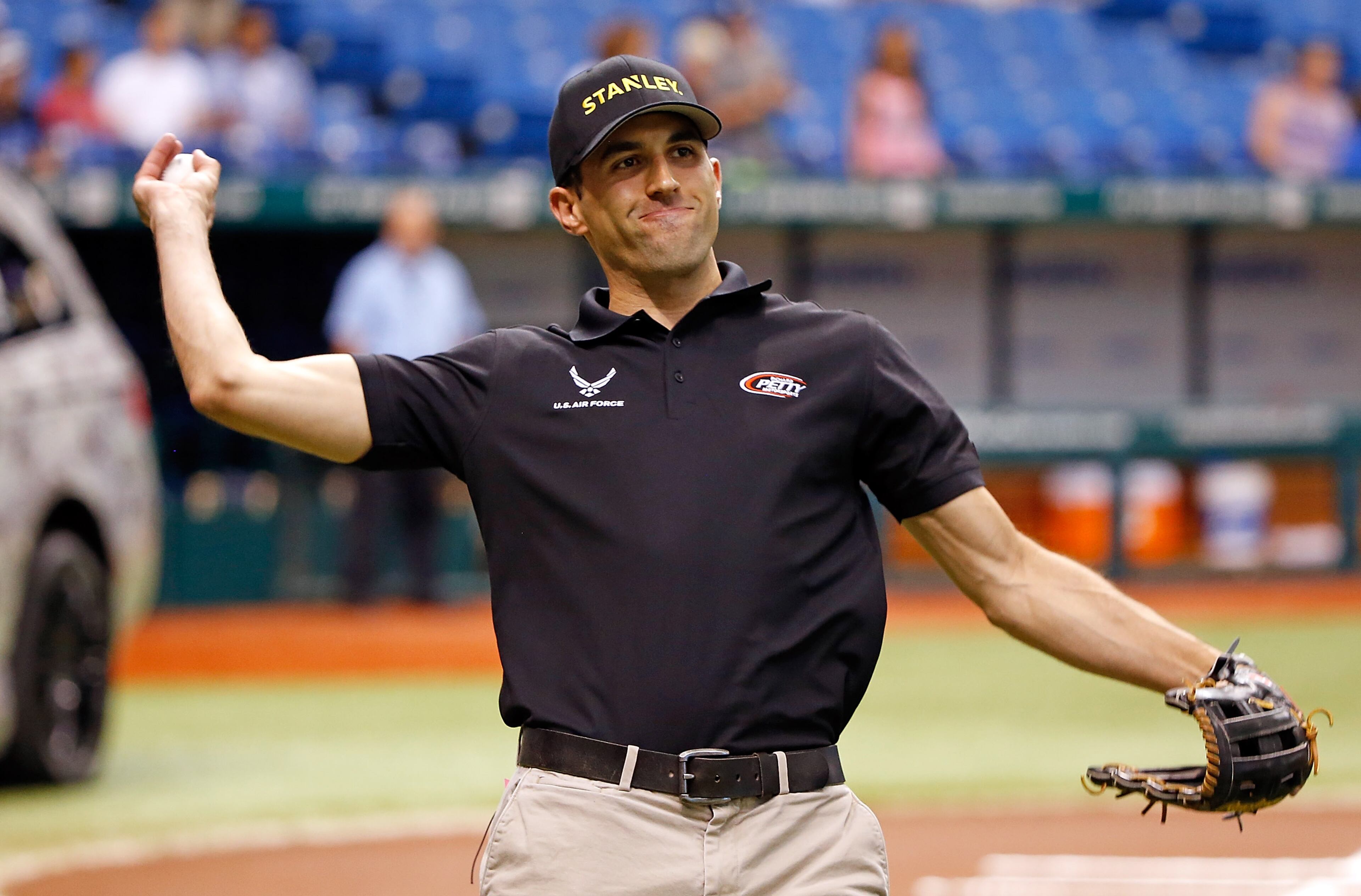NASCAR driver Aric Almirola warms up before throwing out the ceremonial first pitch just before the start of the game between the Tampa Bay Rays and the Toronto Blue Jays at Tropicana Field on June 25, 2013 in St. Petersburg, Florida.