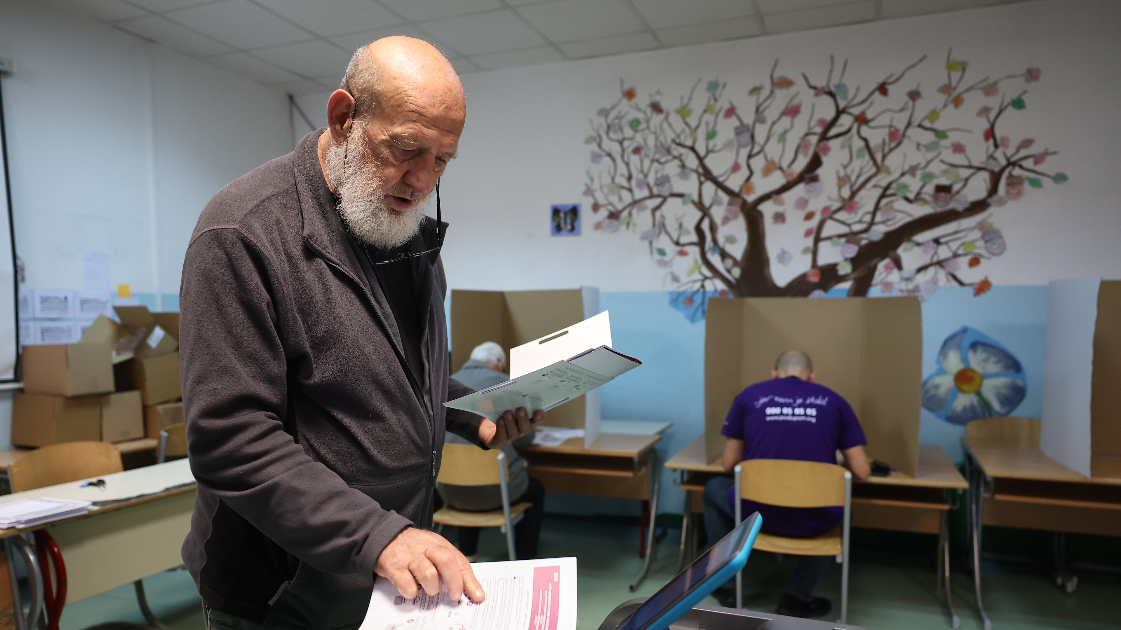 A man places his ballot into an electronic ballot box during the general election in Sarajevo, Bosnia, Sunday, Oct. 4, 2026. (AP Photo/Armin Durgut)