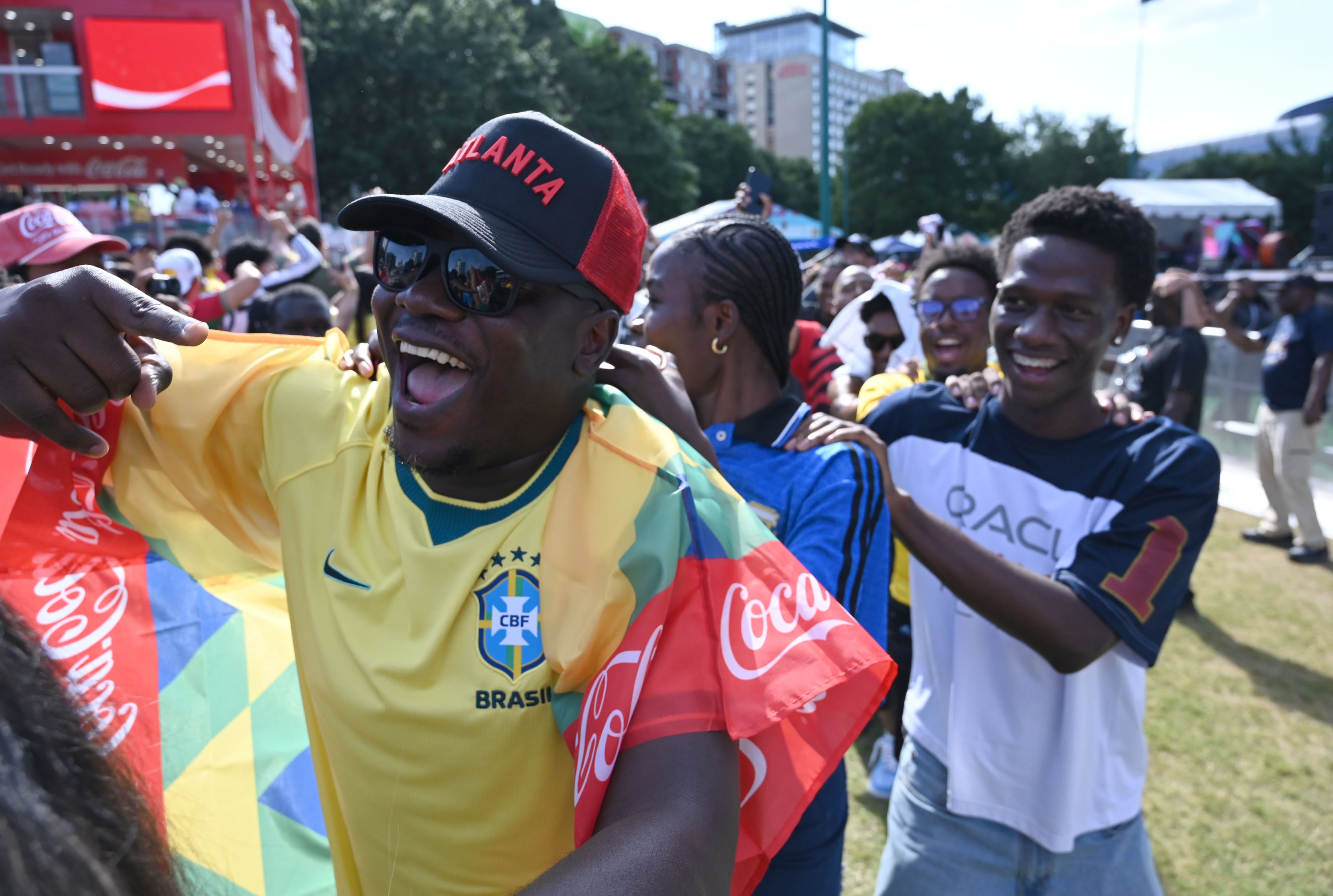Soccer fans mingle and dance while gathering for a watch party ahead of the match between Brazil and Morocco at the FIFA Fan Festival in Centennial Olympic Park. (Hyosub Shin/AJC)