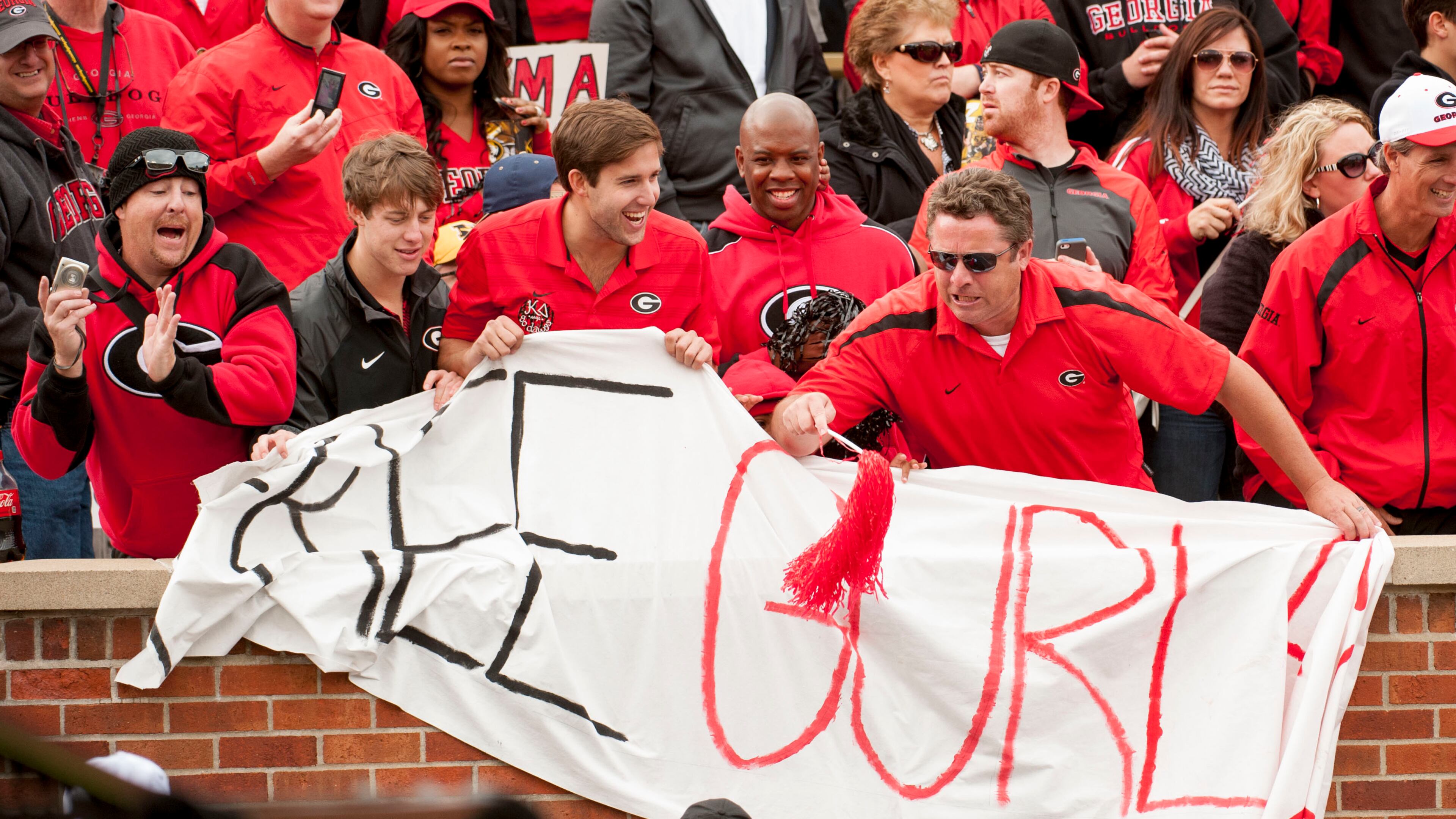 Georgia fans try to keep an usher from tearing down their 'Free Gurley' sign during the fourth quarter of an NCAA college football game against Missouri Saturday, Oct. 11, 2014, in Columbia, Mo. (AP Photo/L.G. Patterson)