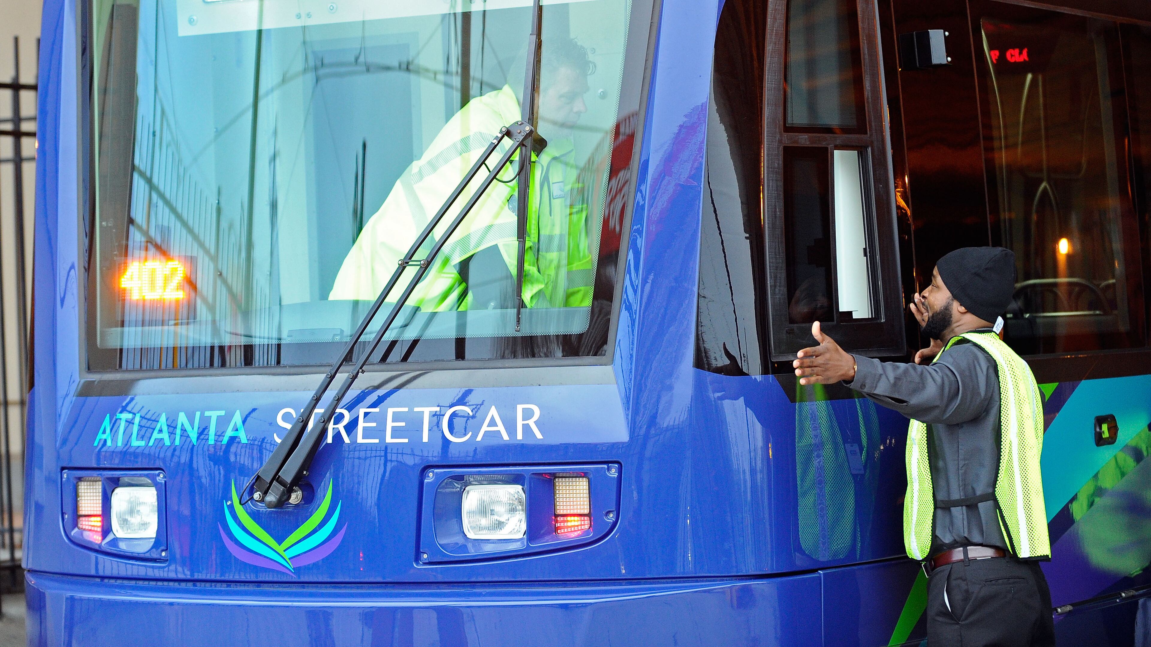 Darius Hall, right, checks the horn and gong operation with Eric Eberlien, left, before its launch later Tuesday, Dec. 30, 2014, in Atlanta. DAVID TULIS / AJC Special