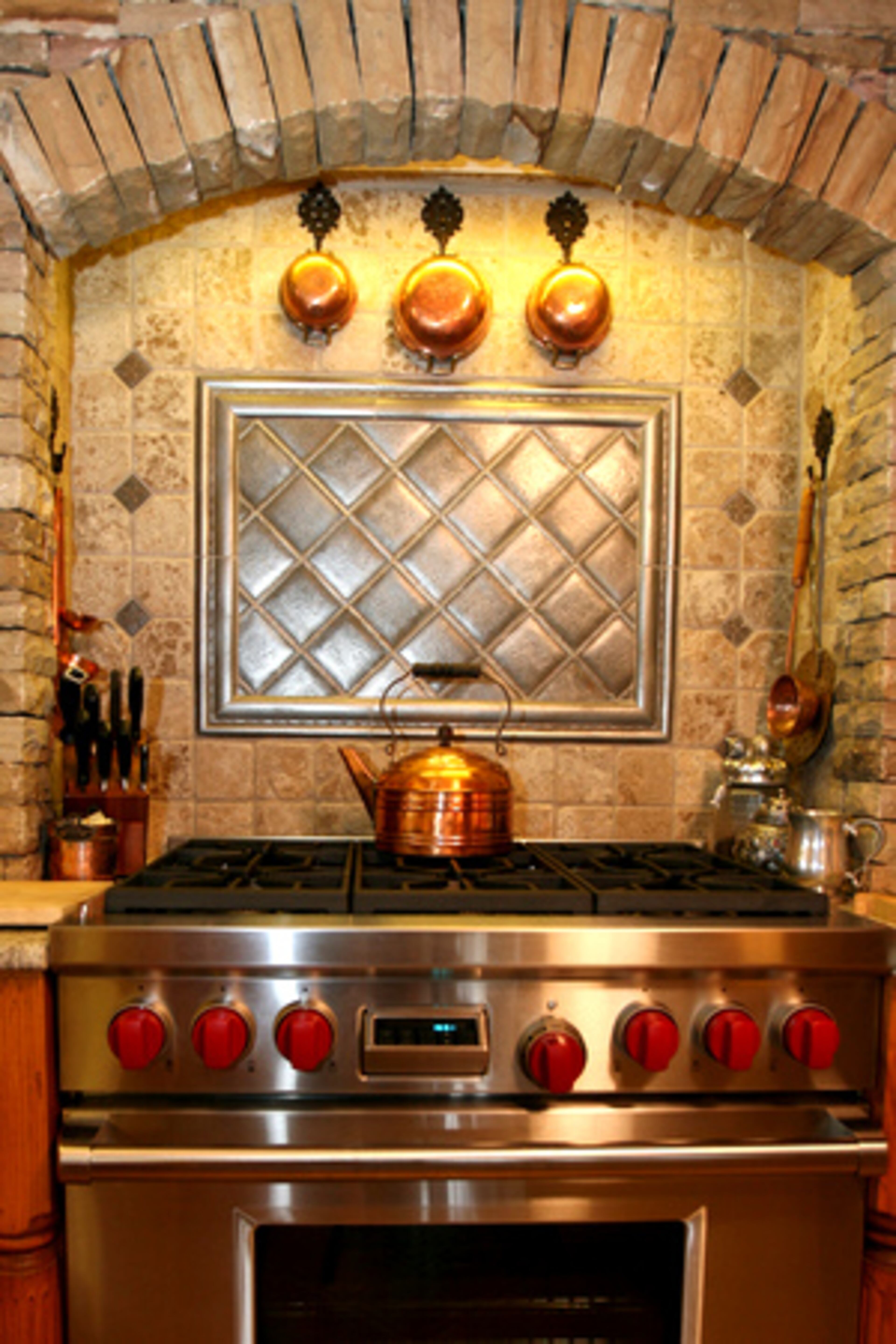 The kitchen includes a beautiful stone arch over the stove.