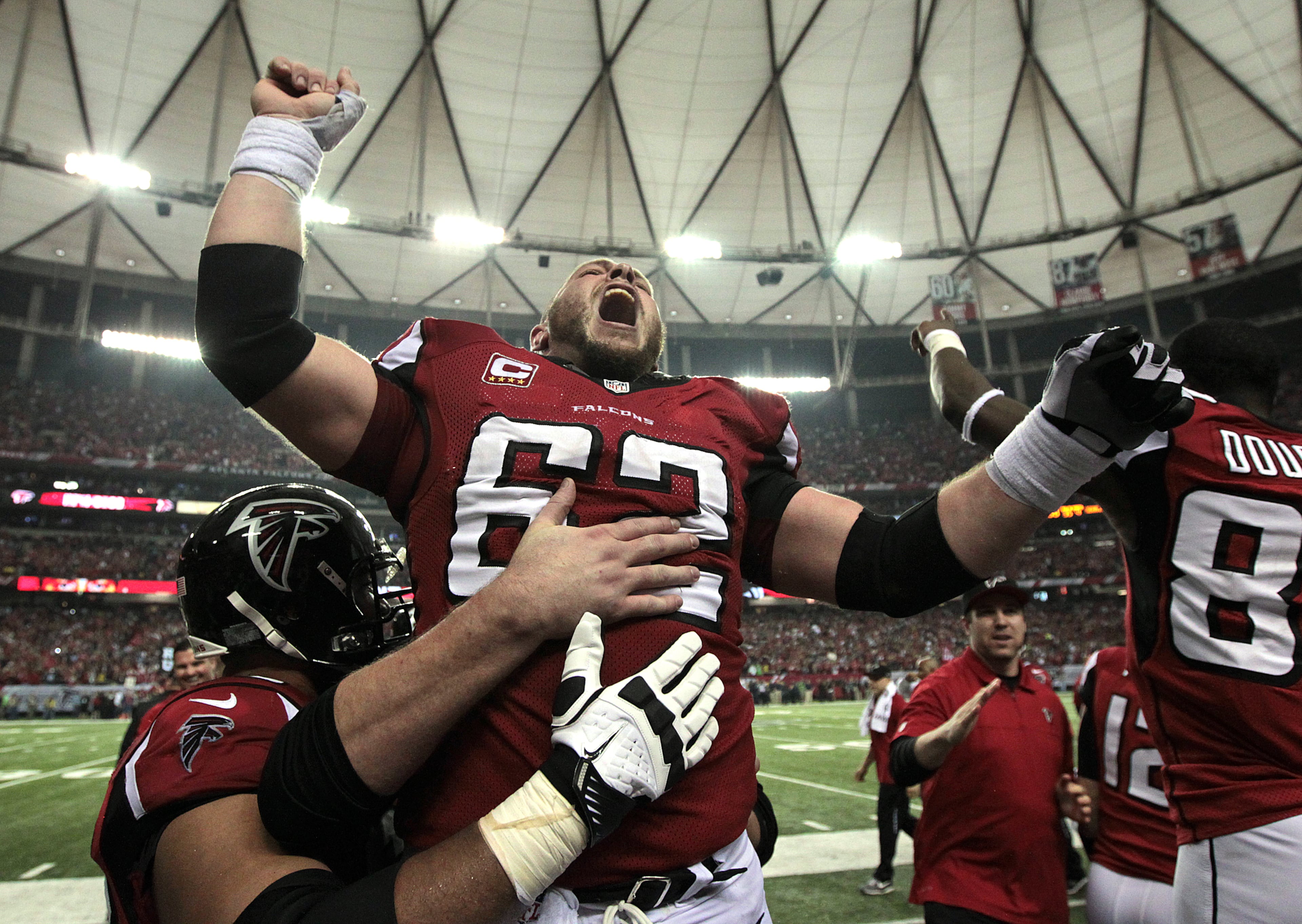 Falcons veteran center Todd McClure lets out a victory yell on the sidelines following kicker Matt Bryant's game winning field goal for a 30-28 victory over the Seahawks on Jan. 13, 2013. CURTIS COMPTON / CCOMPTON@AJC.COM