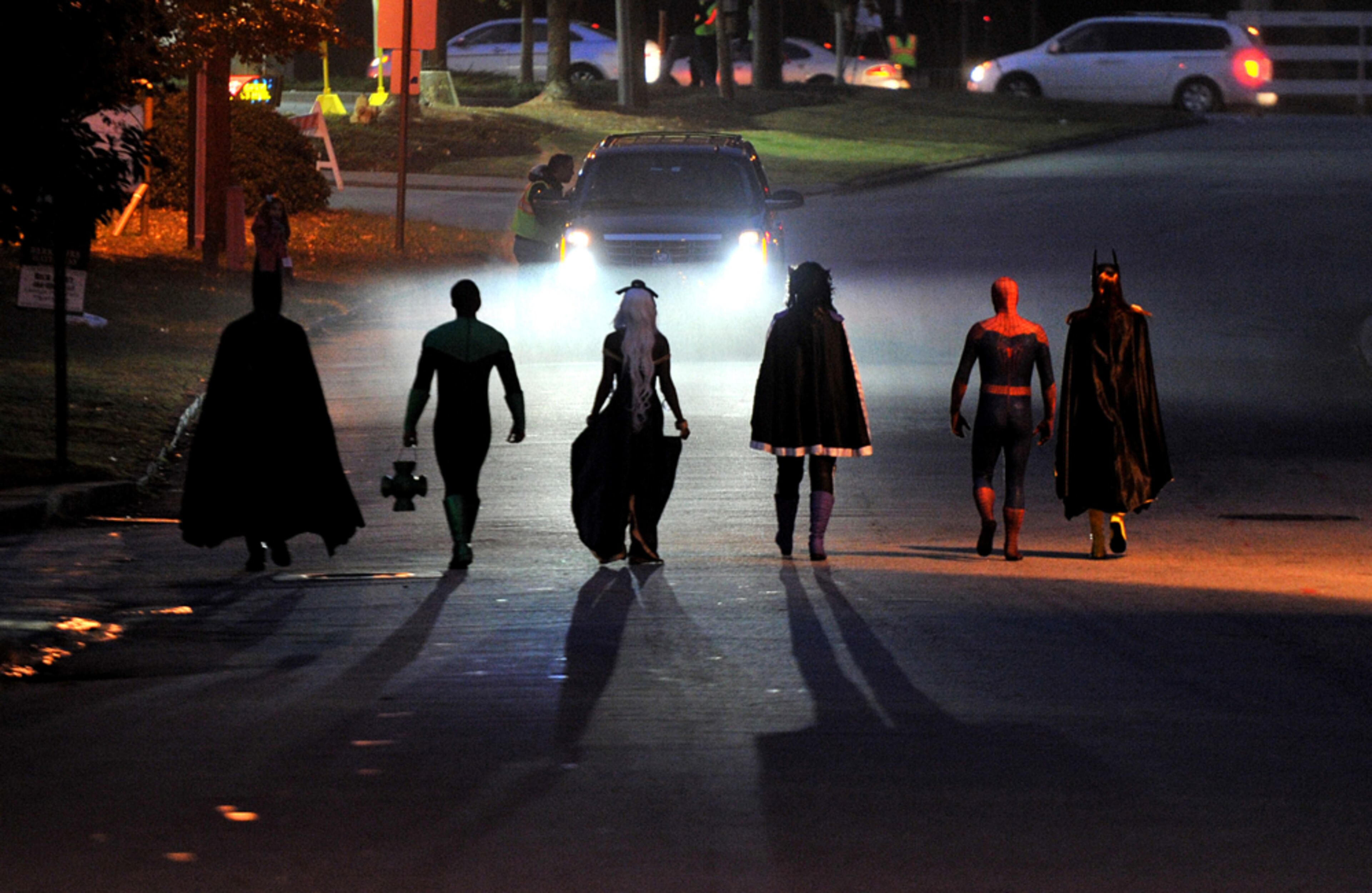 SUPERHERO STROLL--November 8, 2014 Atlanta - Superheroes walk up to a limousine to escort DJ Pitts, 4, before DJ pushes the button to implode the 19-story former Executive Park Motor building at the corner of I-85 and North Druid Hills Road on Saturday morning, November 8, 2014. One superhero patient at Children's Healthcare of Atlanta, four-year-old DJ Pitts, wore many capes during his six-month hospital stay after accidentally swallowing a dangerous engine cleaning material. From Batman and Superman capes to a homemade cape that proudly said "Super DJ," he has overcome near impossible obstacles. When he dons a cape, nothing is out of reach. To show support for DJ and brave kids like him, the Atlanta community was celebrating Cape Day ATL to surprise and delight Children's patients with photos on social media that show residents wearing capes in their honor. The morning after Cape Day, on Saturday, Nov. 8, DJ and a group of superheroes demonstrated their strength and bravery by pressing a button that imploded a 19-story building. The property is the former Executive Park Motor building at the corner of I-85 and North Druid Hills Road. HYOSUB SHIN / HSHIN@AJC.COM