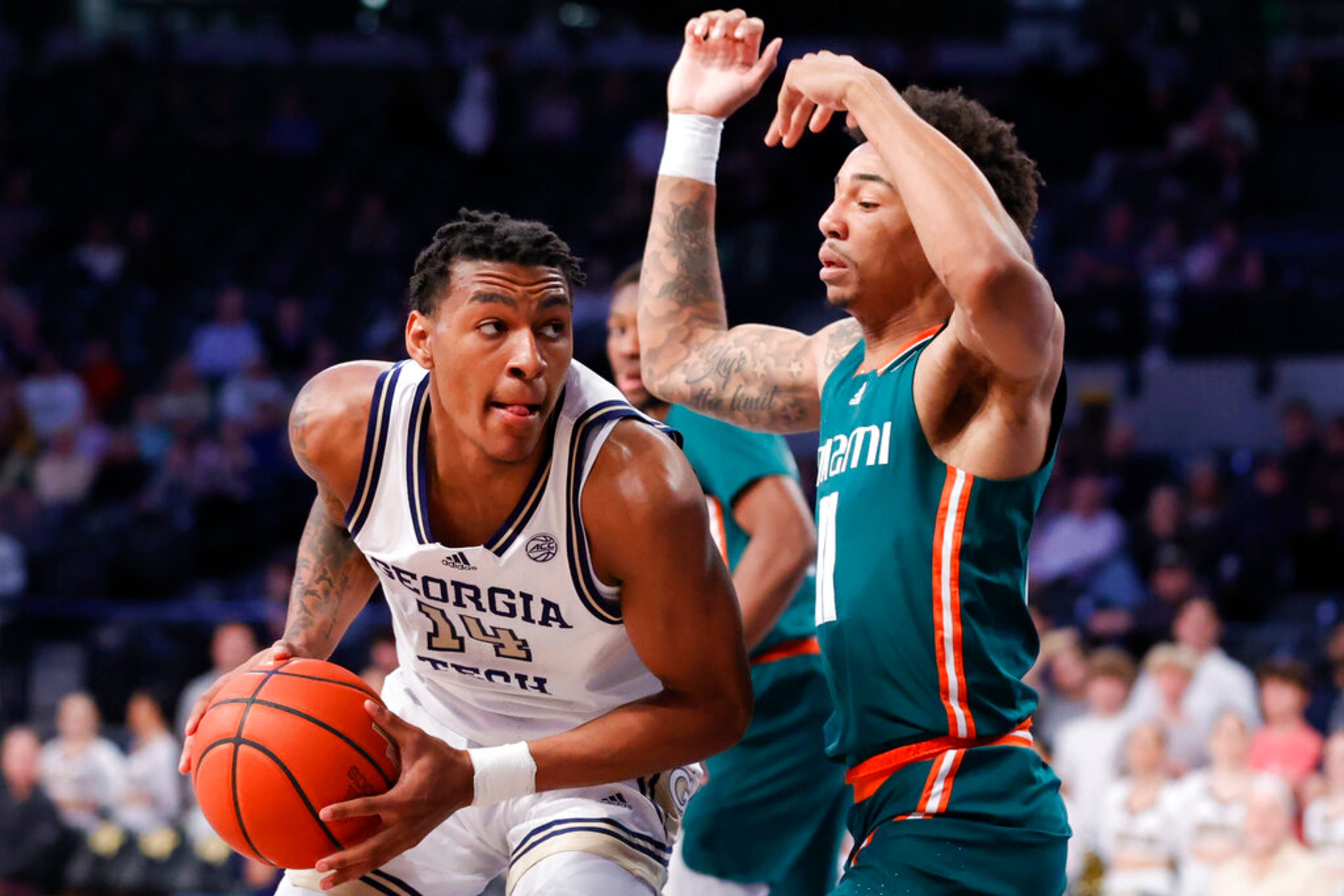 Georgia Tech forward Jalon Moore, left, works gainst Miami guard Jordan Miller during the first half of an NCAA college basketball game Wednesday, Jan. 4, 2023, in Atlanta. (AP Photo/Alex Slitz)