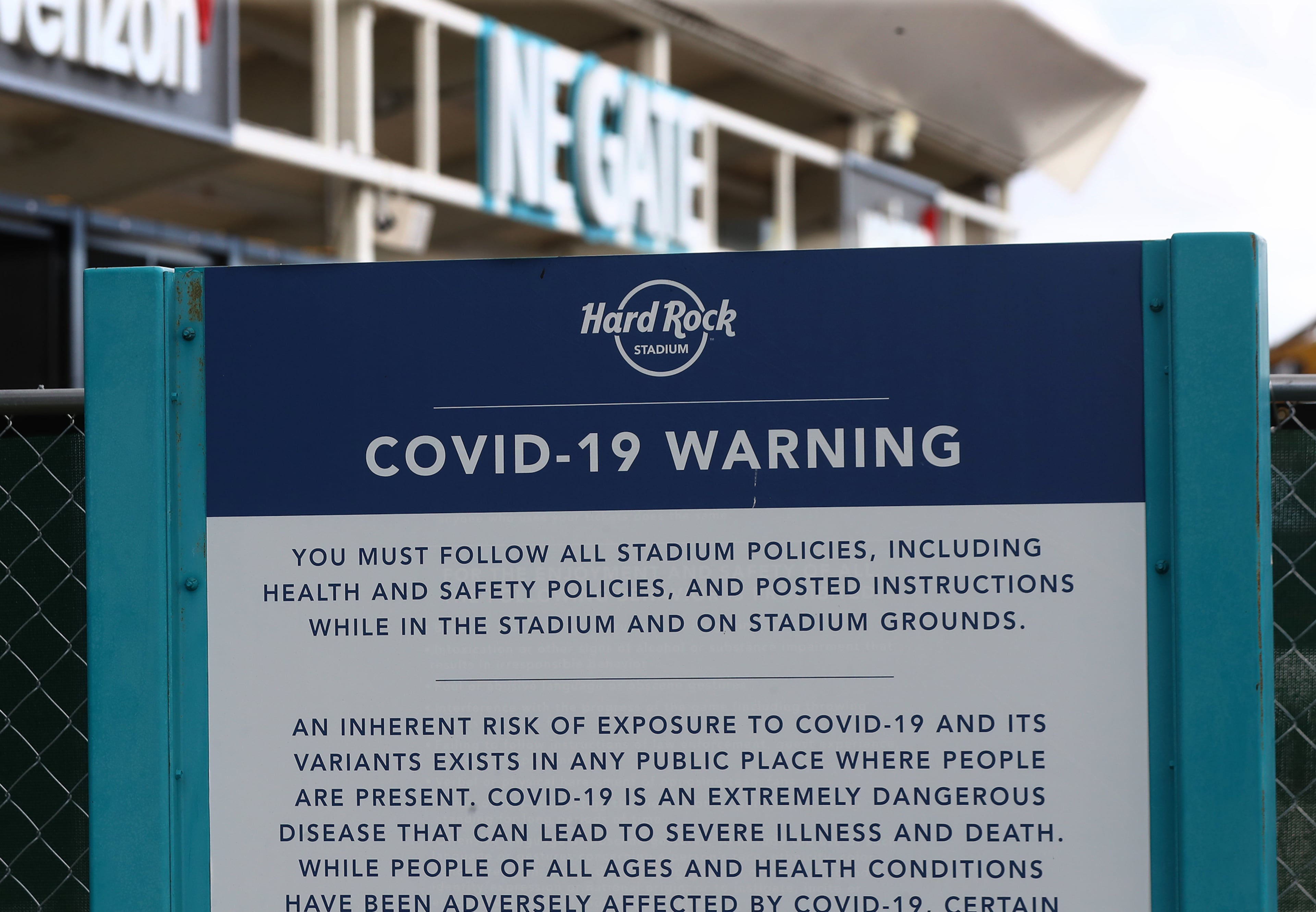 A sign outside the northeast gate at Hard Rock Stadium warns fans of Covid-19 policies on Wednesday, Dec 29, 2021, where Georgia will play Michigan in the Orange Bowl CFP Semifinal in Miami Gardens. “Curtis Compton / Curtis.Compton@ajc.com”`