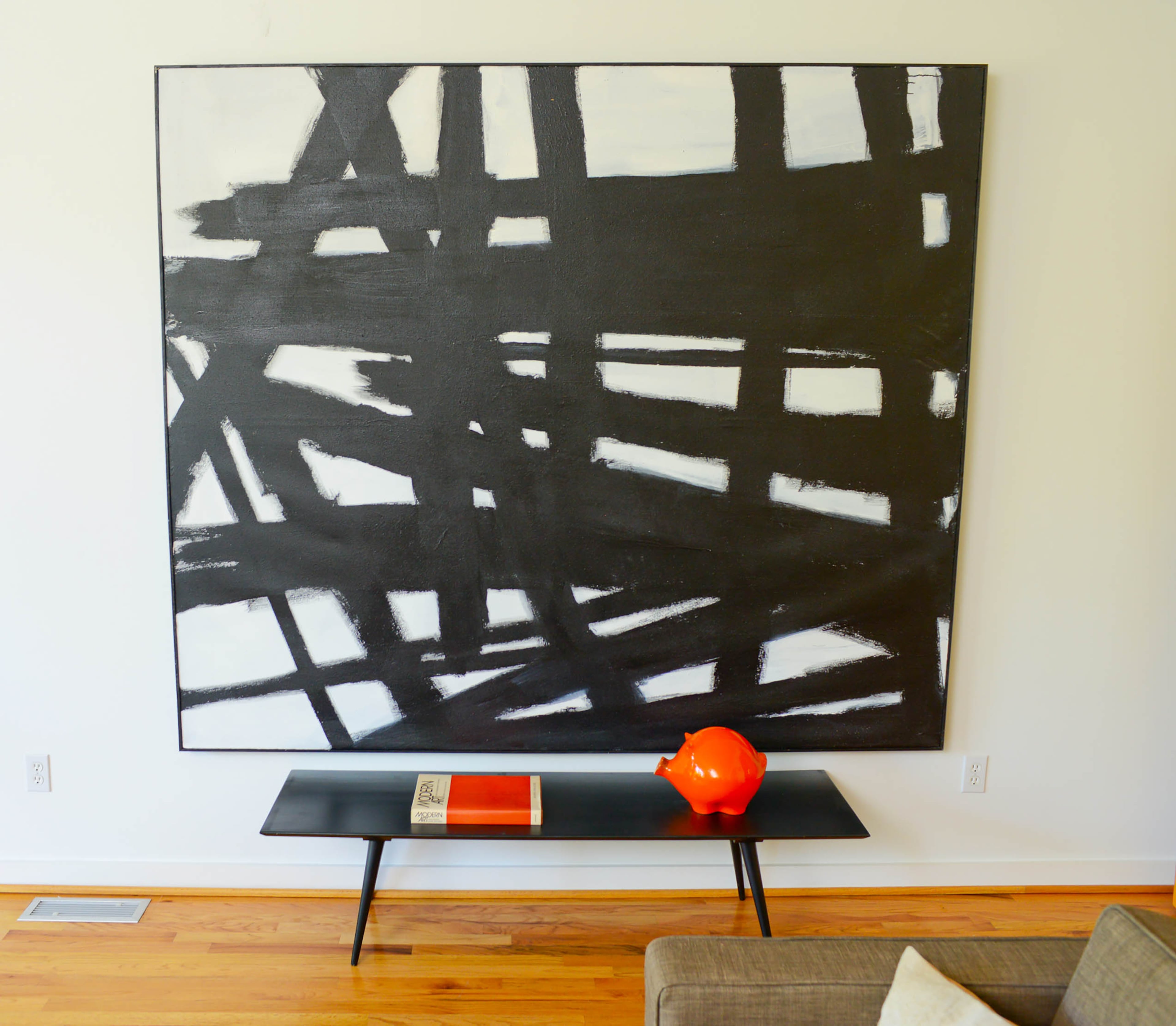 Henry's art collection includes a black-and-white painting by Alabama artist Thomas Cook in the upstairs home office.