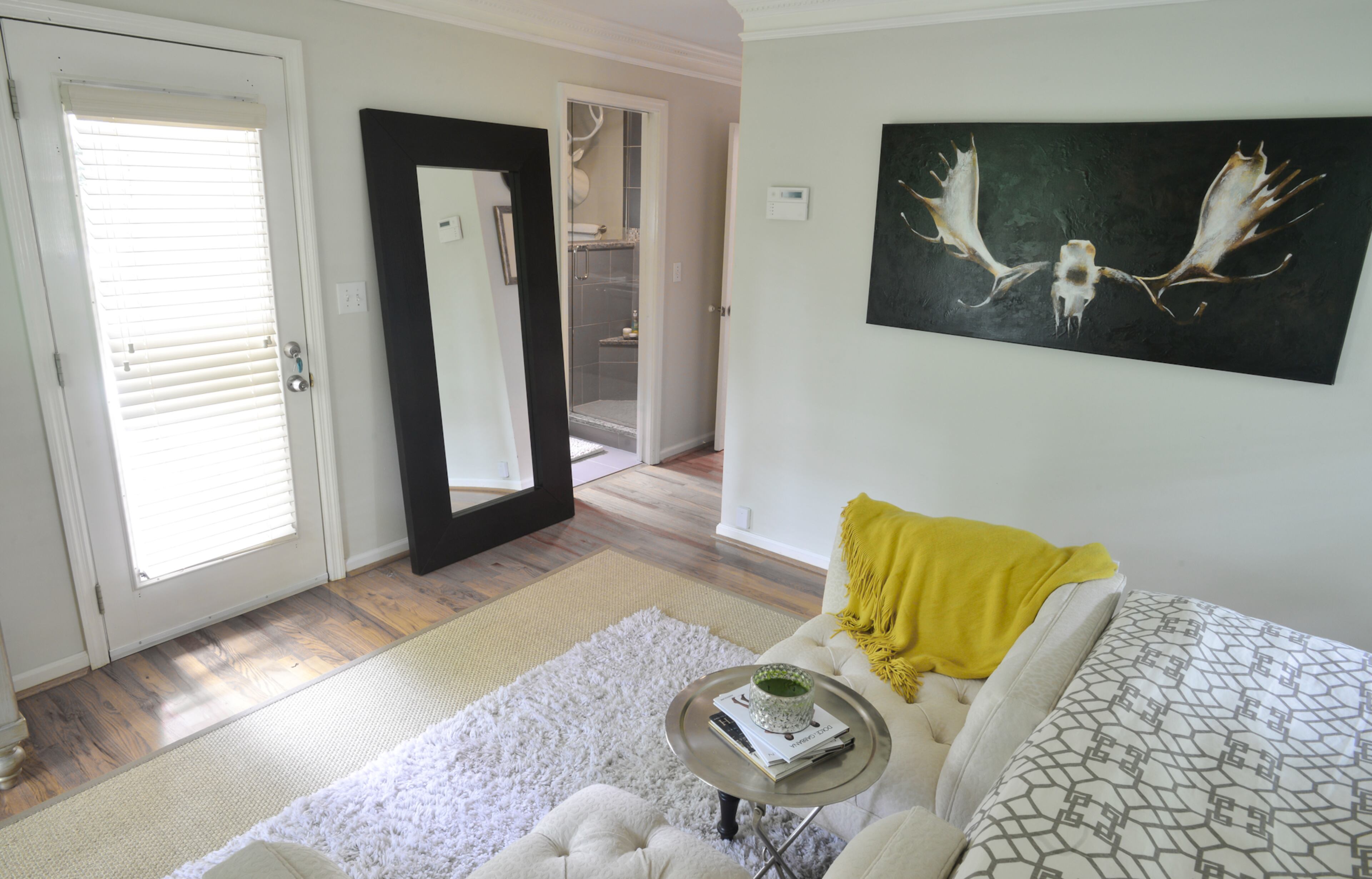 The bedroom also has a large mirror from Ikea. The skull artwork, purchased at an art gallery in Atlanta, contrasts with the gray walls and hints of gold and yellow in the room. "I love the colors in it and the way it works in that kind of space," Betsy Clay said.