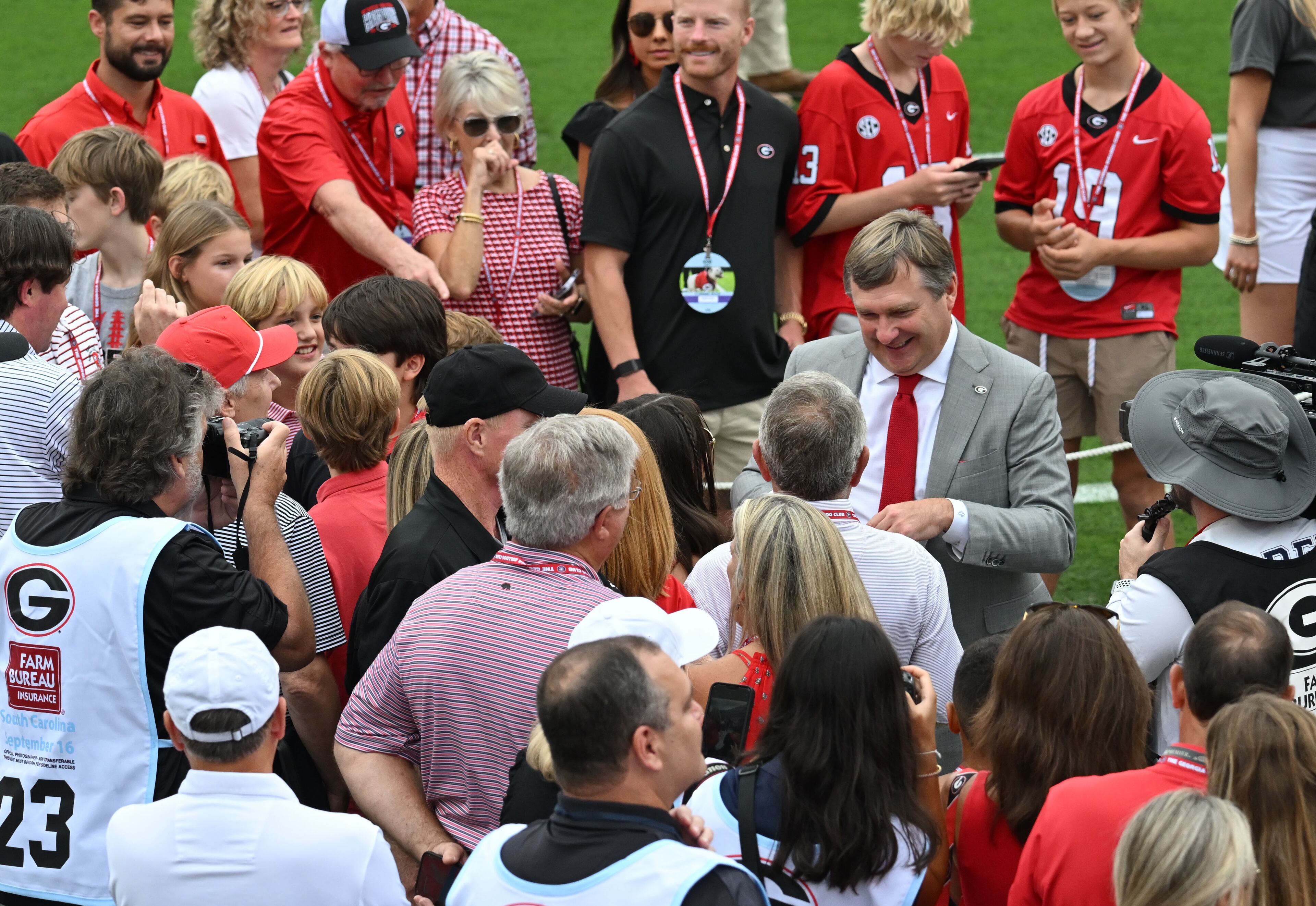 Georgia's head coach Kirby Smart is surrounded by fans as players and coaching staff participate in the Dawg Walk before their game against South Carolina in an NCAA football game at Sanford Stadium, Saturday, September 16, 2023, in Athens. (Hyosub Shin / Hyosub.Shin@ajc.com)