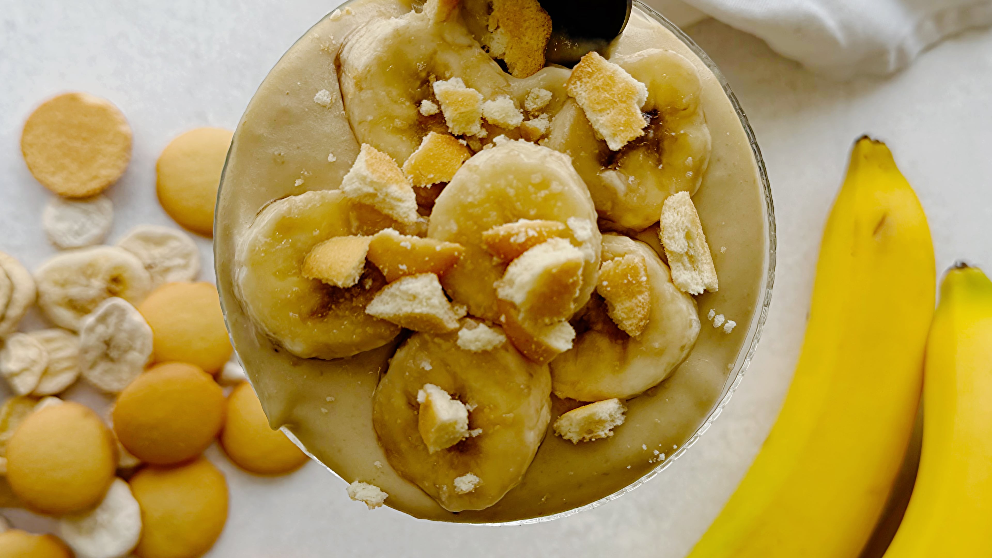 Homemade banana pudding made with freeze-dried bananas in the custard is topped with fresh banana slices and crushed vanilla wafers.