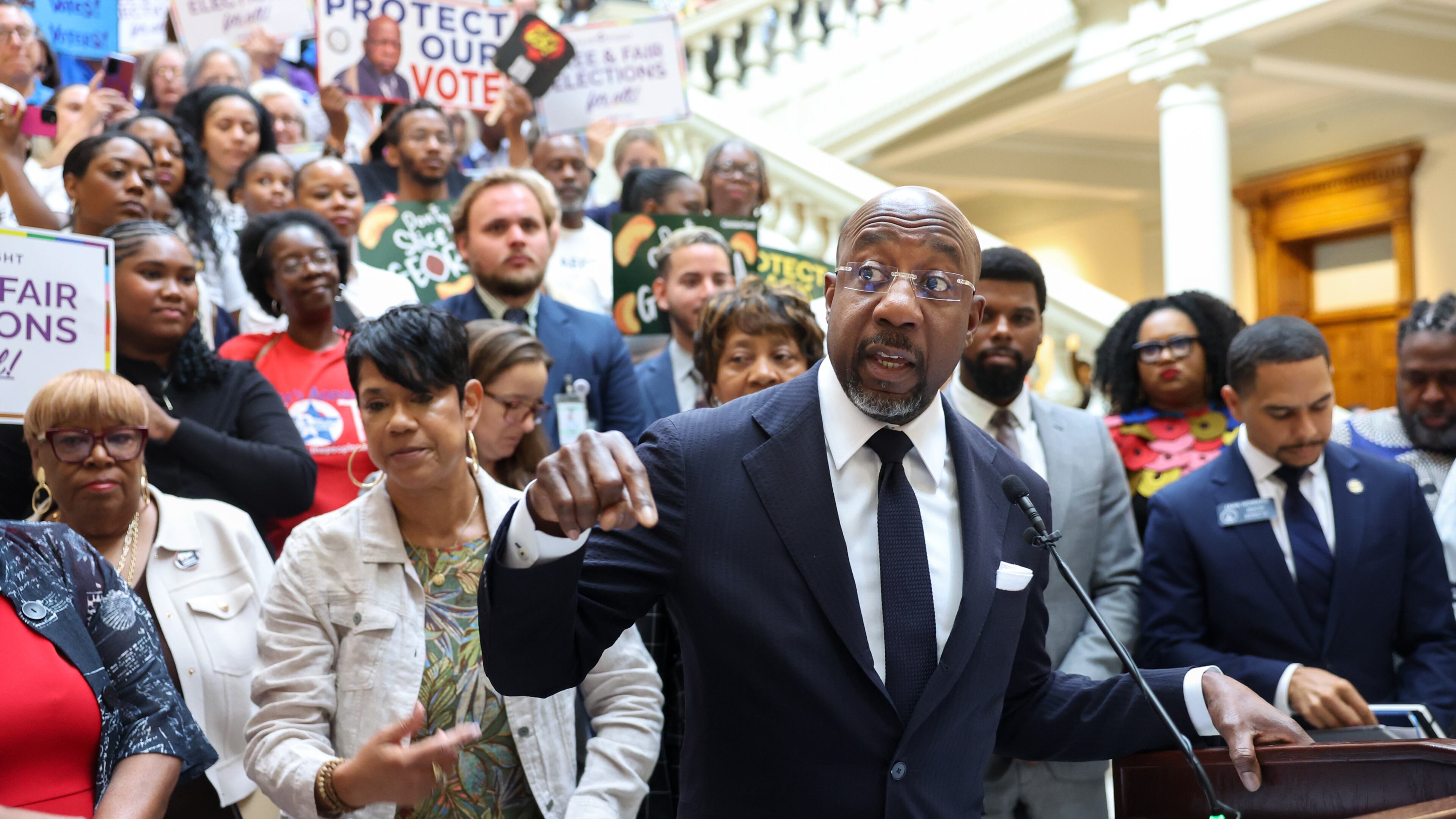 Democratic U.S. Sen. Raphael Warnock speaks at a news conference before the state Legislature convenes for a special session in Atlanta last month. (Arvin Temkar/AJC)