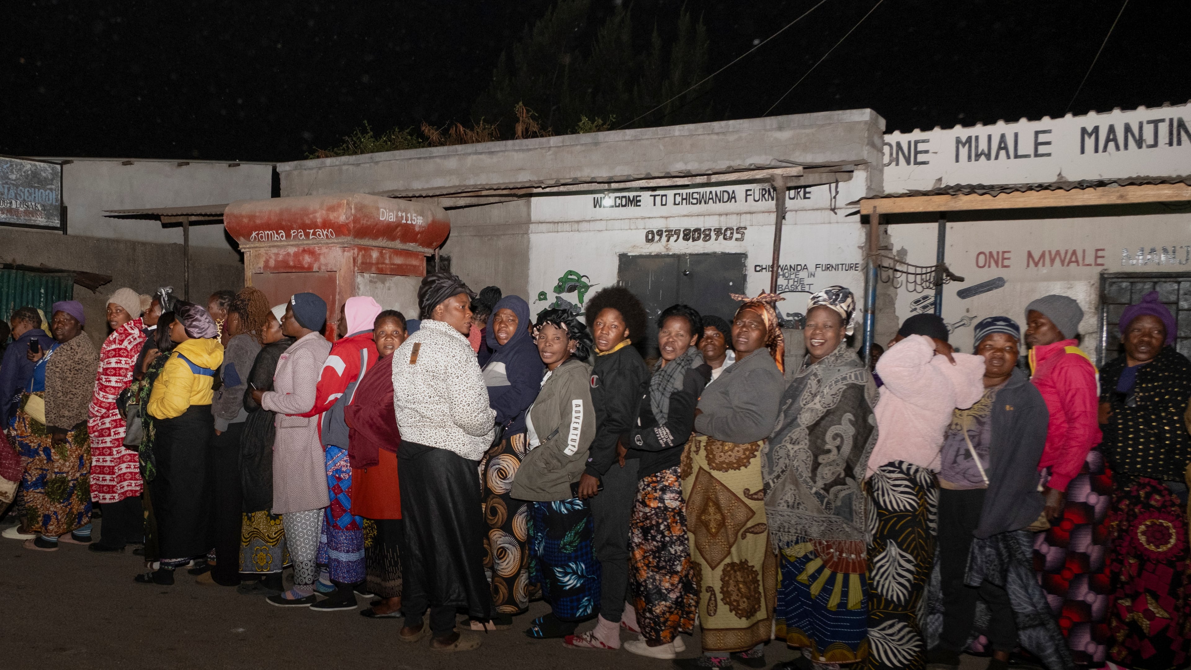 Zambians queue outside a polling station on the outskirts of Lusaka, Zambia, Thursday, Aug. 13, 2026. (AP Photo/Anita Reed)