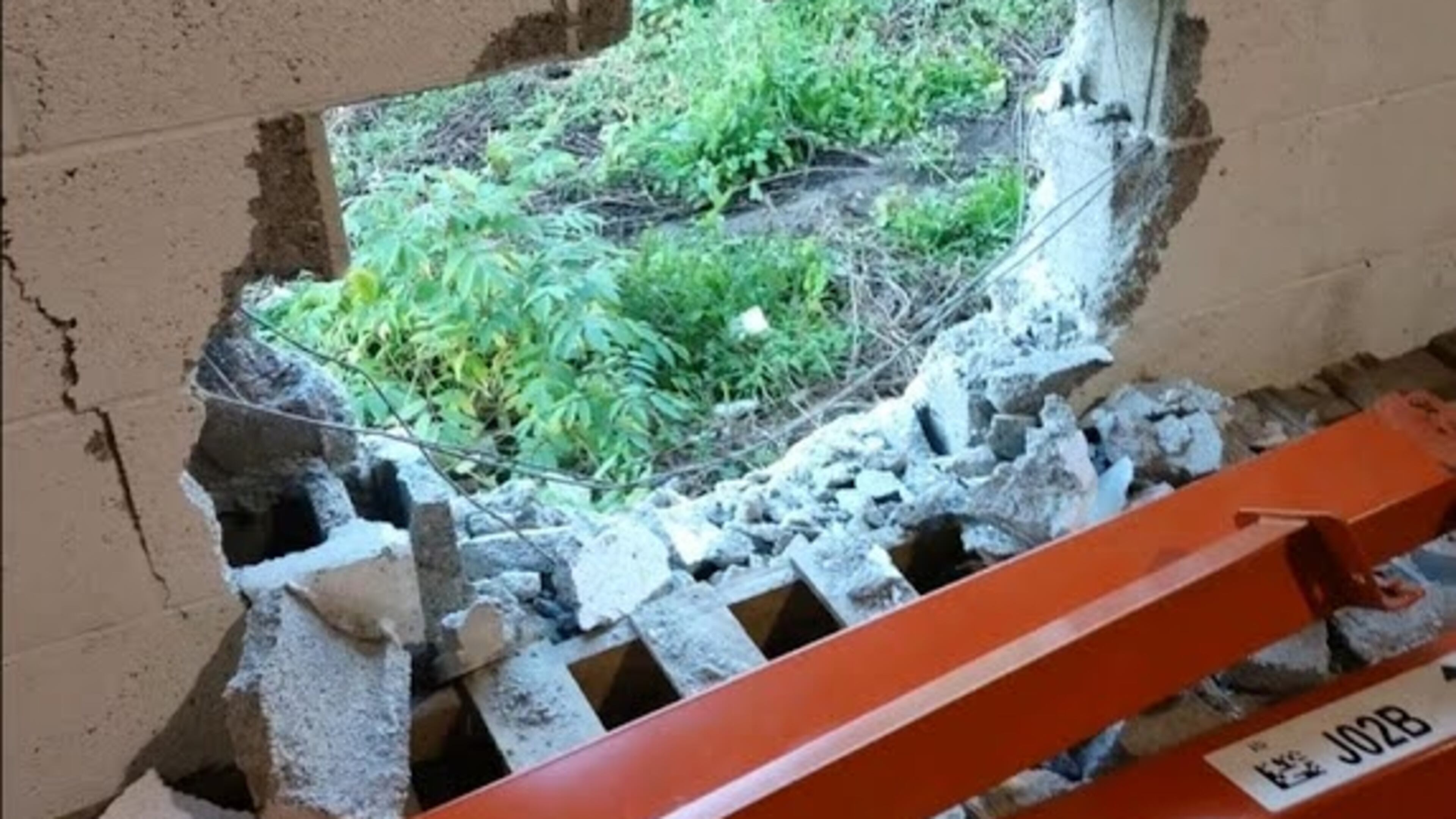 A hole was punched through a cinderblock wall at the Empty Stocking Fund warehouse.