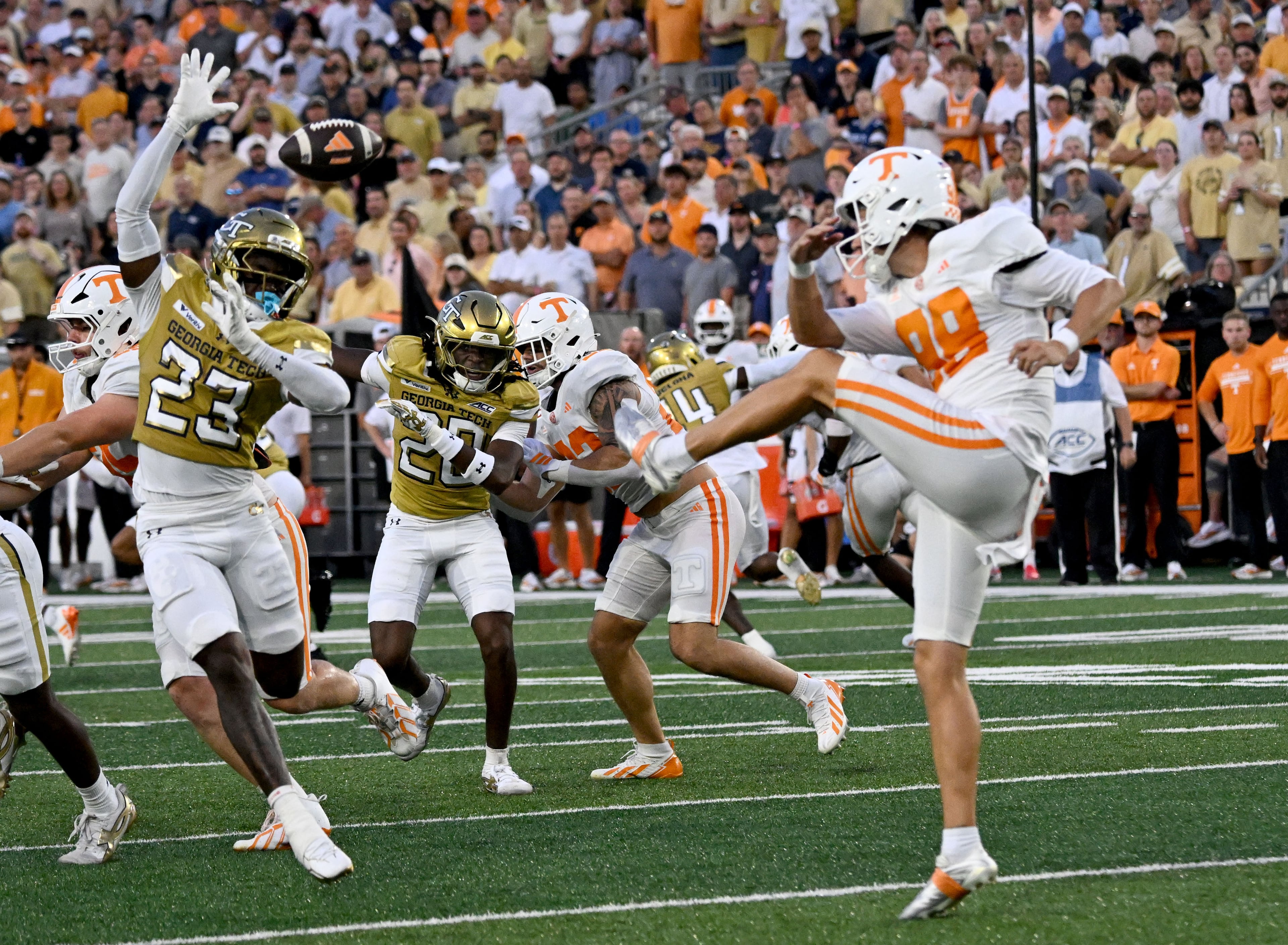 Tennessee punter Jackson Ross (98) has his punt blocked by Georgia Tech defensive back Trae Stevenson Jr. (23) during the first half of an NCAA college football game at Bobby Dodd Stadium on Saturday, Sept. 12, 2026, in Atlanta. (Hyosub Shin/AJC)