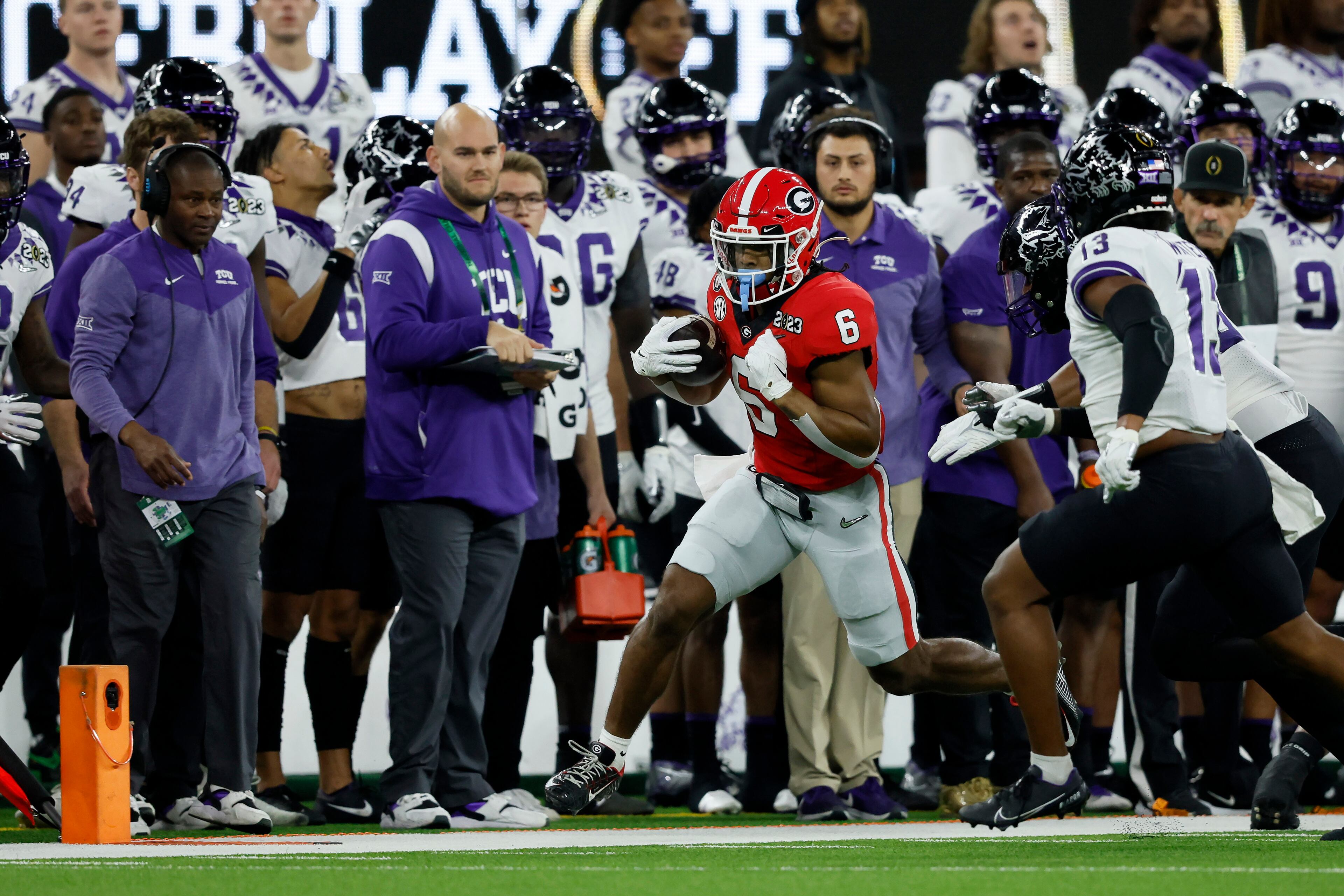 Georgia Bulldogs running back Kenny McIntosh (6) runs past TCU Horned Frogs linebacker Dee Winters (13) during the first half of the College Football Playoff National Championship at SoFi Stadium in Los Angeles on Monday, January 9, 2023. (Jason Getz / Jason.Getz@ajc.com)