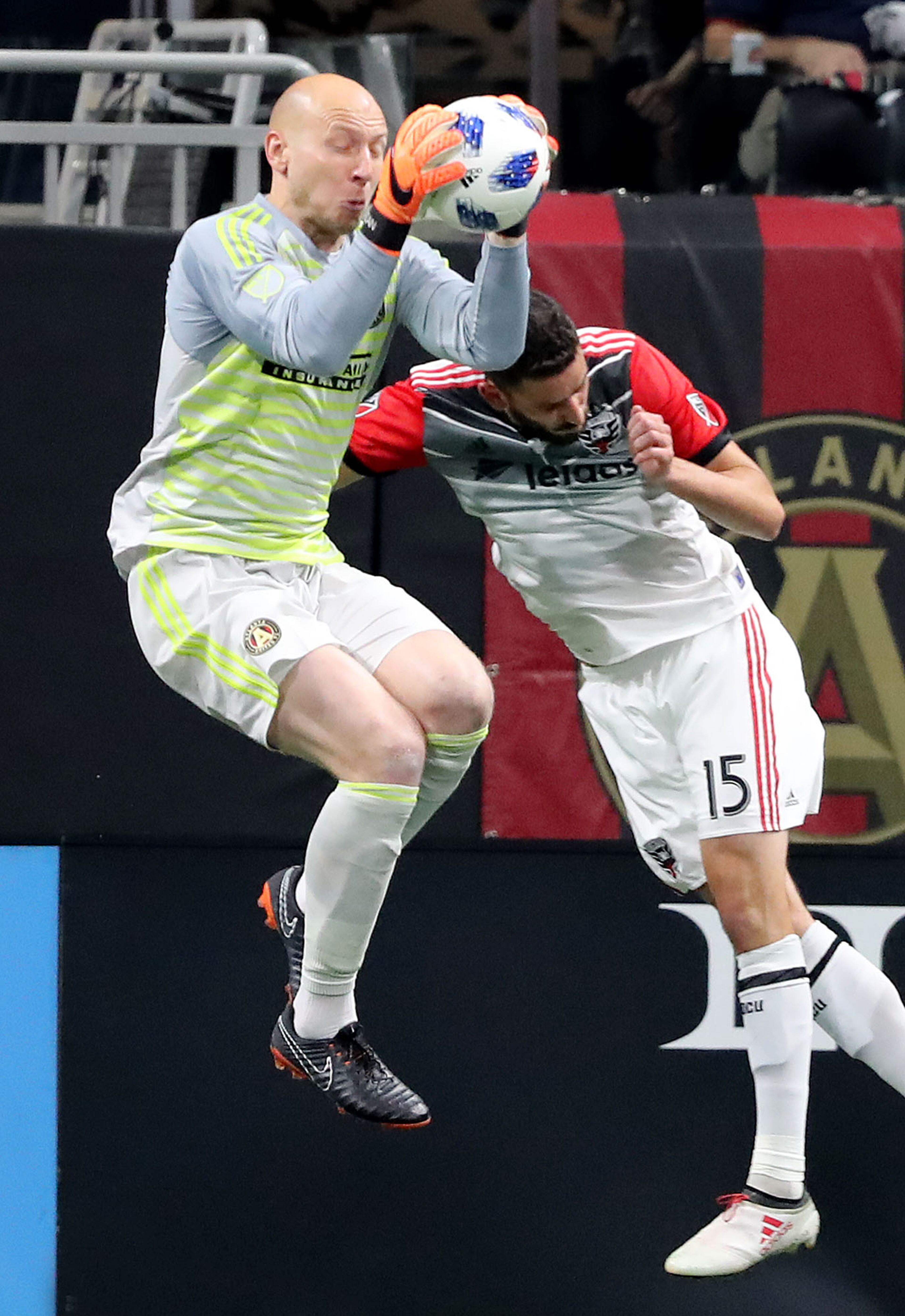 March 11, 2018 Atlanta: Atlanta United goalkeeper Brad Guzan gets to the ball before D.C. United player Steven Birnbaum to save a shot on goal during the second half in a MLS soccer match on Sunday, March 11, 2018, in Atlanta. Curtis Compton/ccompton@ajc.com