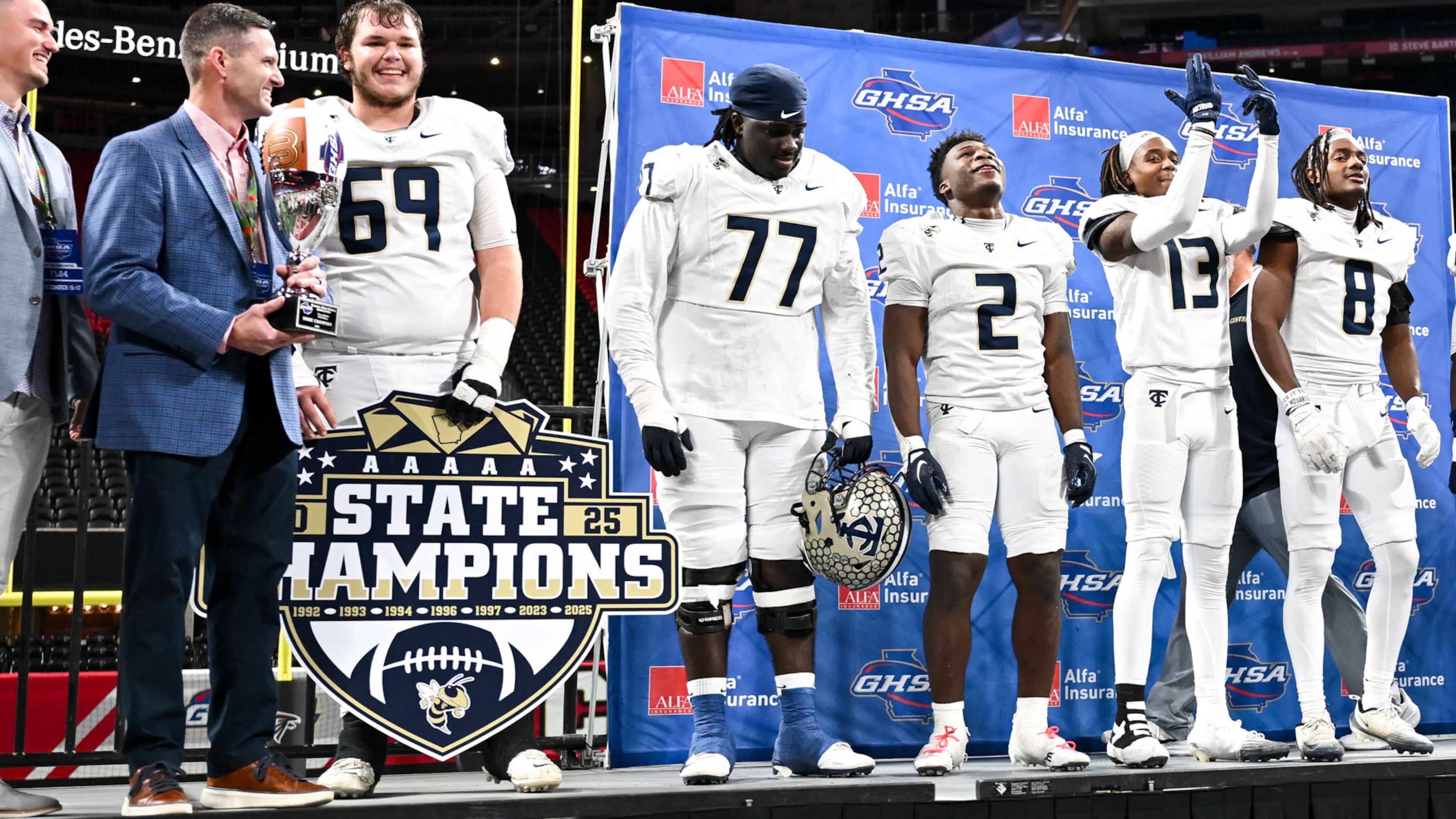 Deontavis Cooper (77), center, is shown with his teammates after the Thomas County Central Yellow Jackets beat the Gainesville Red Elephants 62-21 to win their Class 5A championship game Wednesday, Dec. 17, 2025, at Mercedes-Benz Stadium. (Daniel Varnado for the AJC)